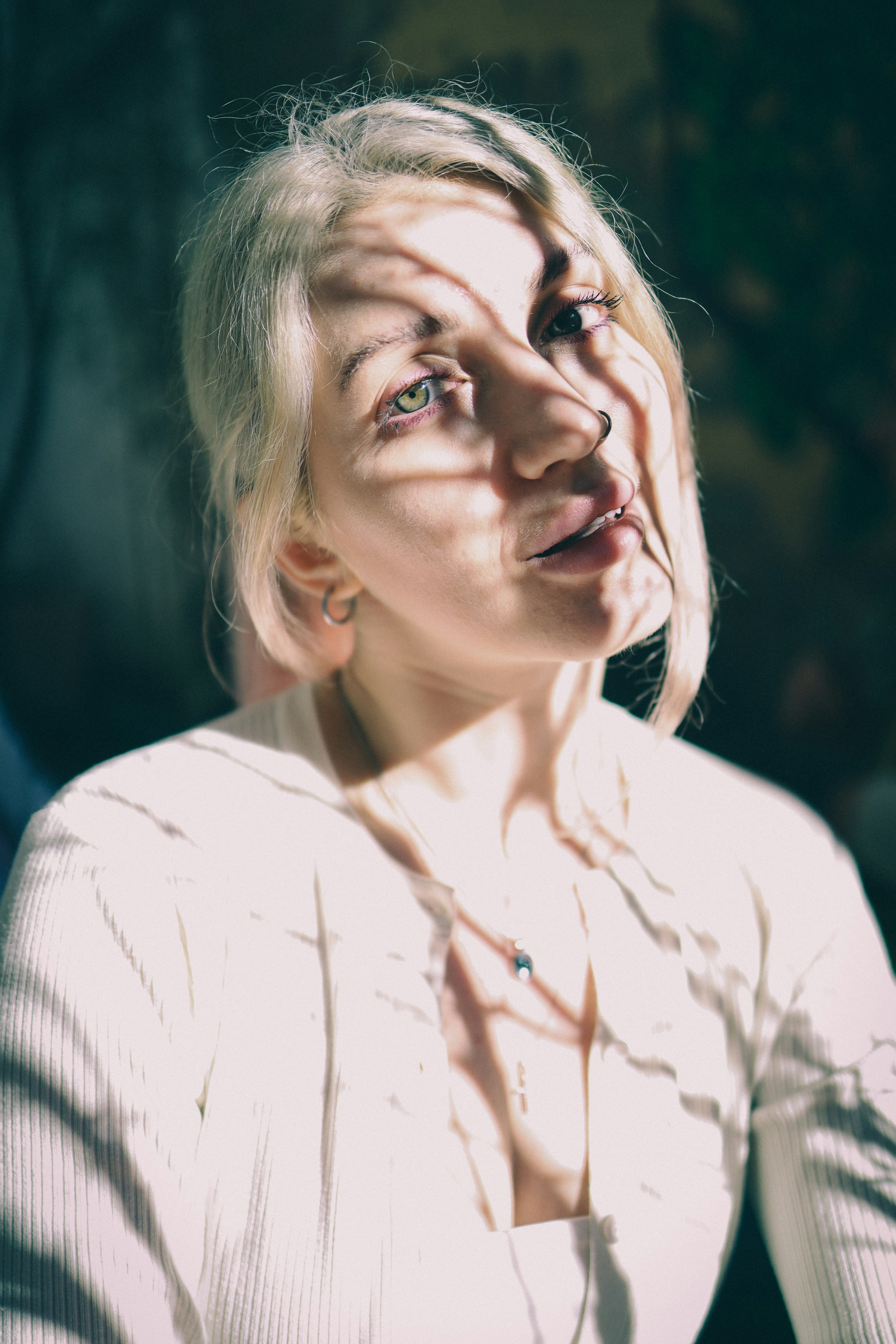 Woman with blonde hair and shadows on face