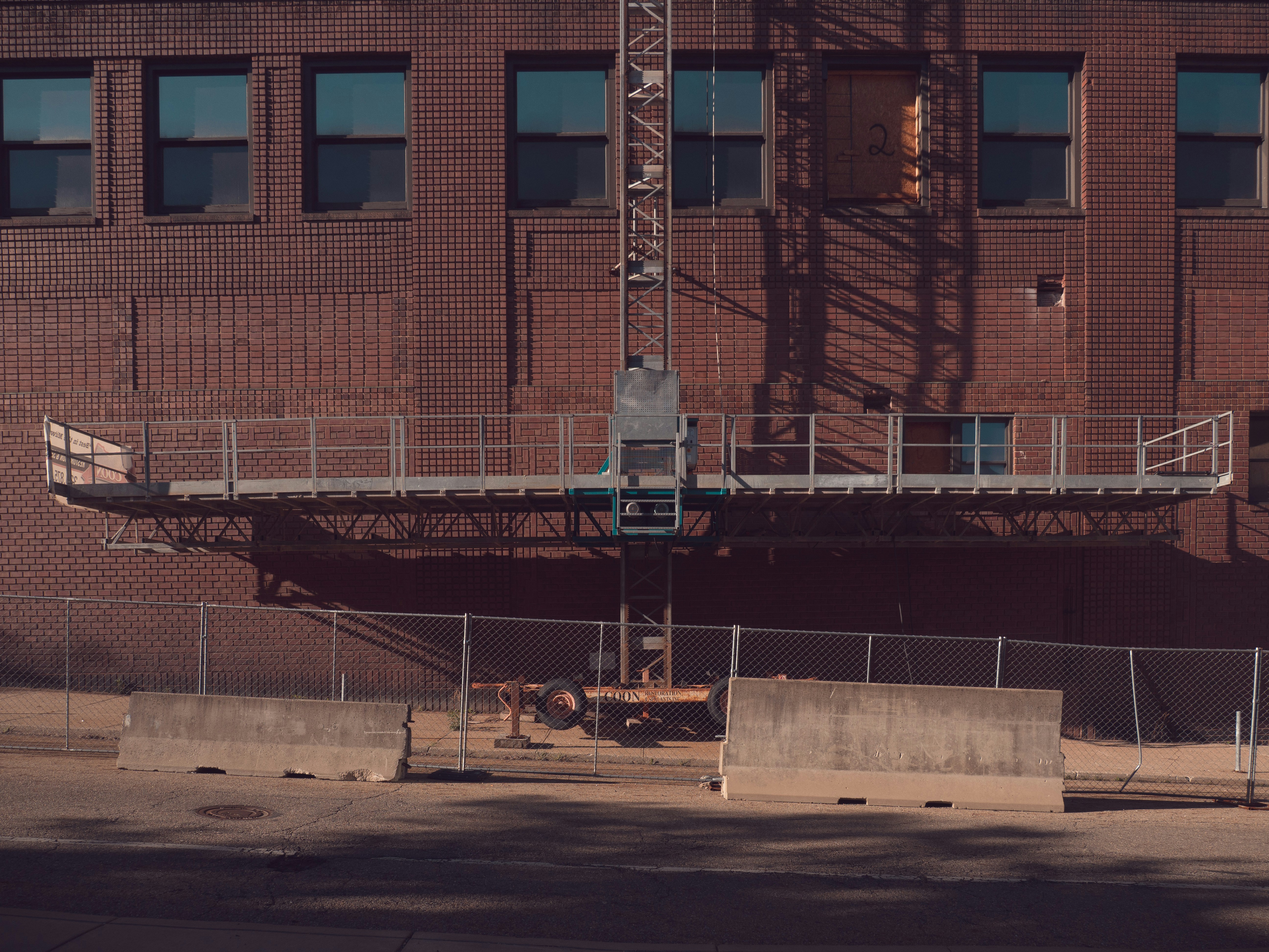 Scaffolding attached to a brick building exterior.