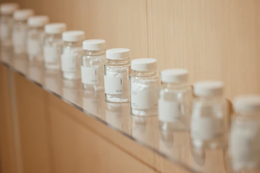 Small glass bottles with white caps lined up