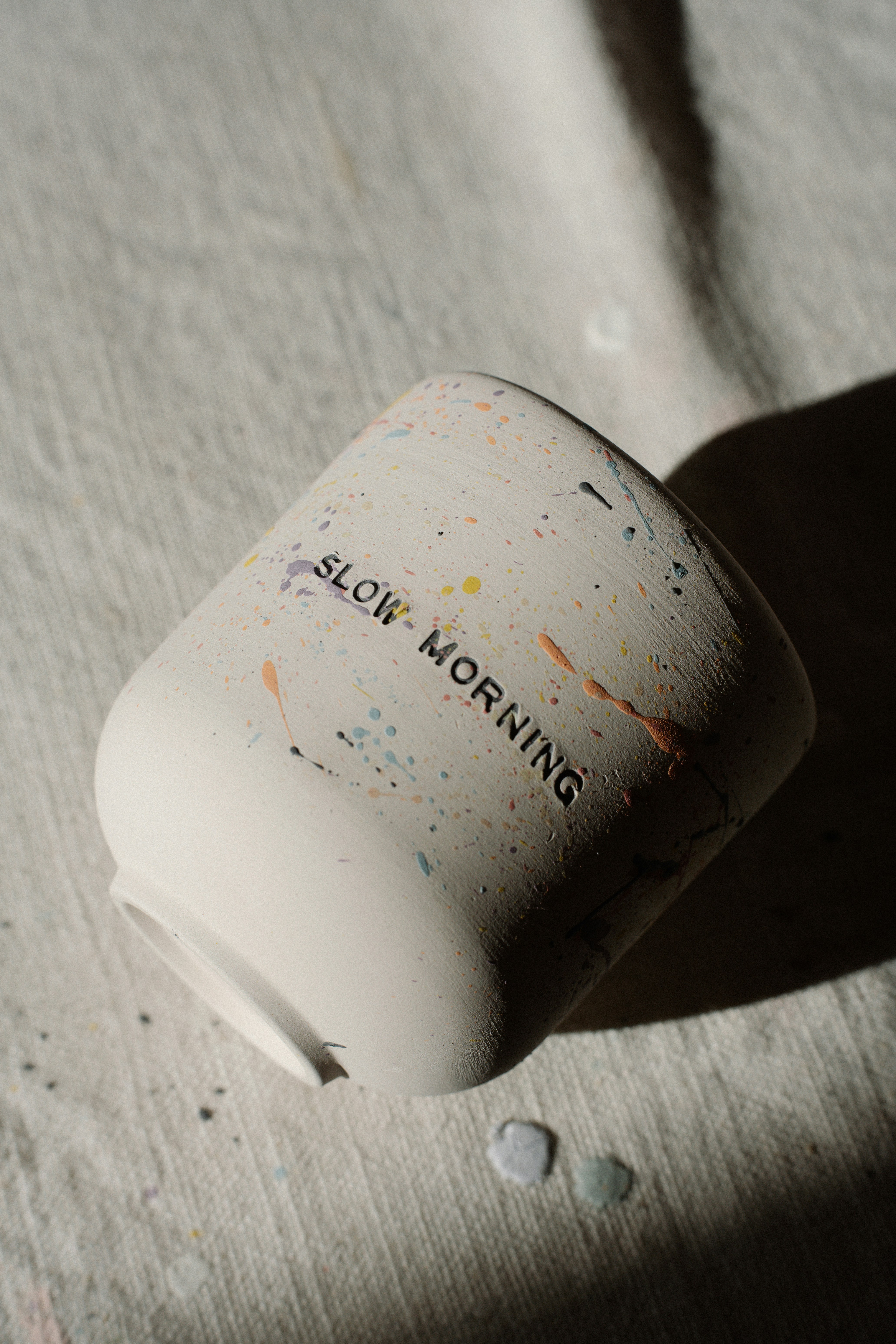 A white mug with 'slow morning' written on it.