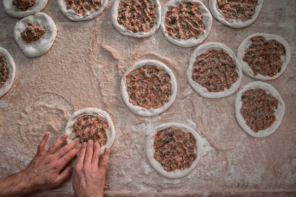 Hands preparing dough on a kitchen counter