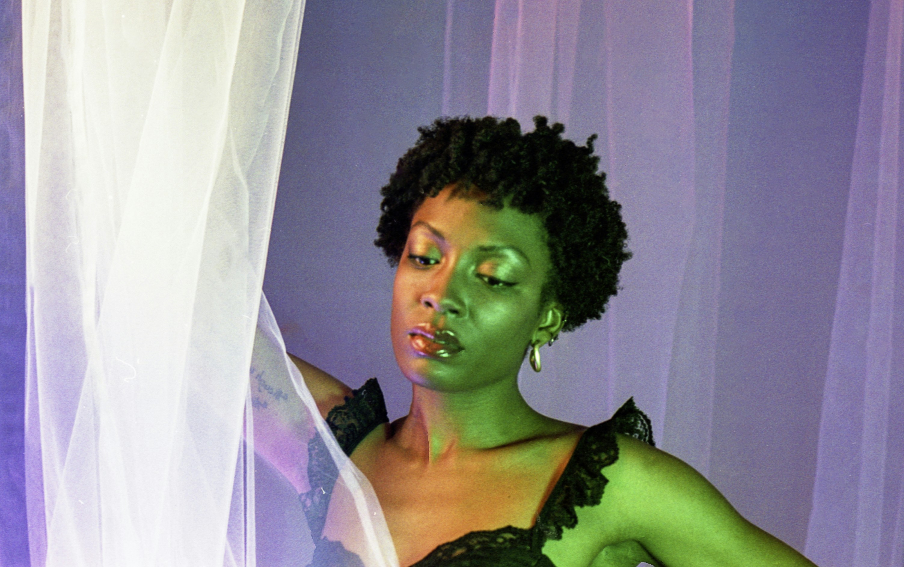 Woman with green face paint and black dress