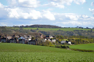 A small village nestled in a green, rolling landscape.