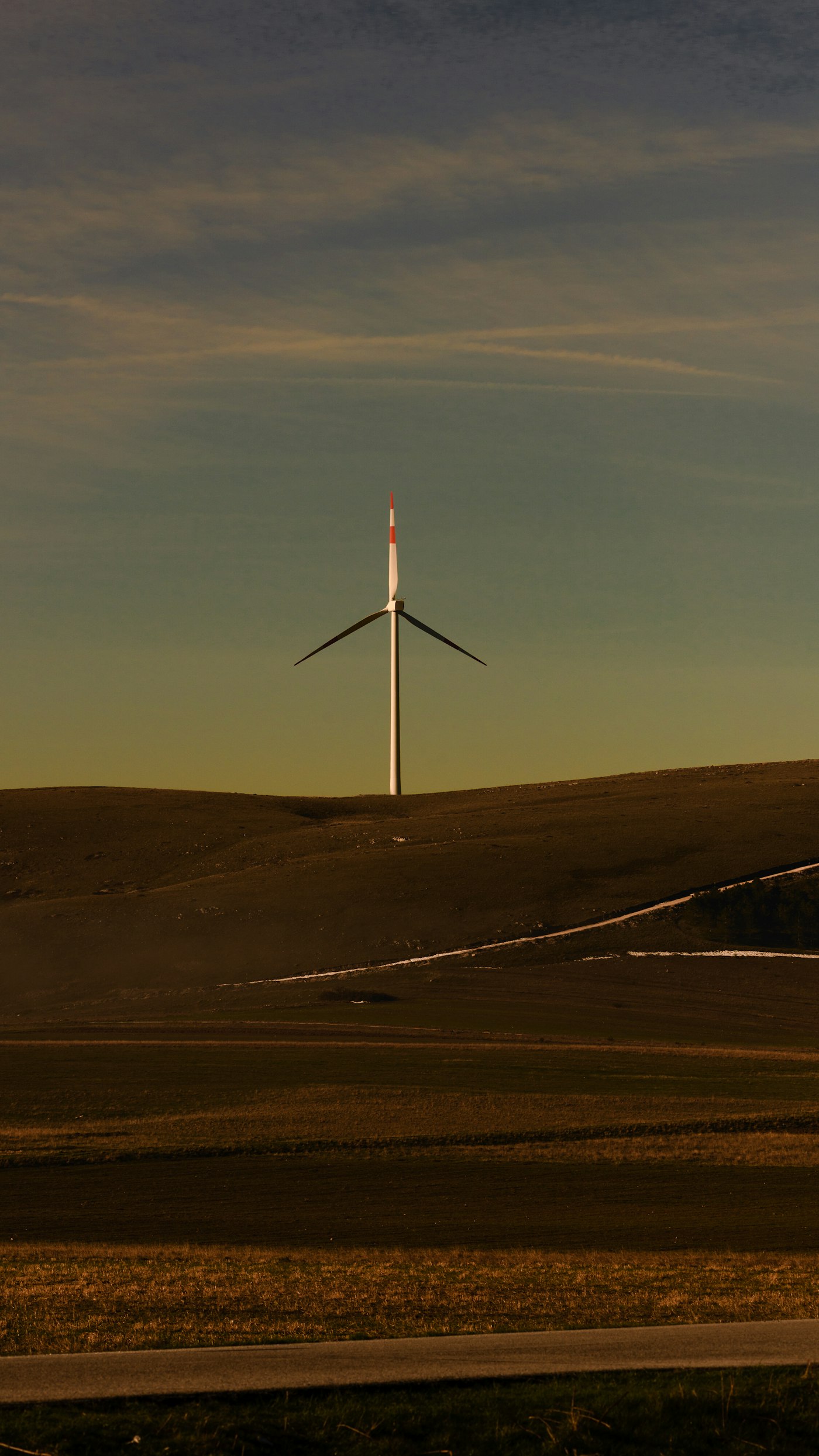 Wind turbine on a rolling green hill