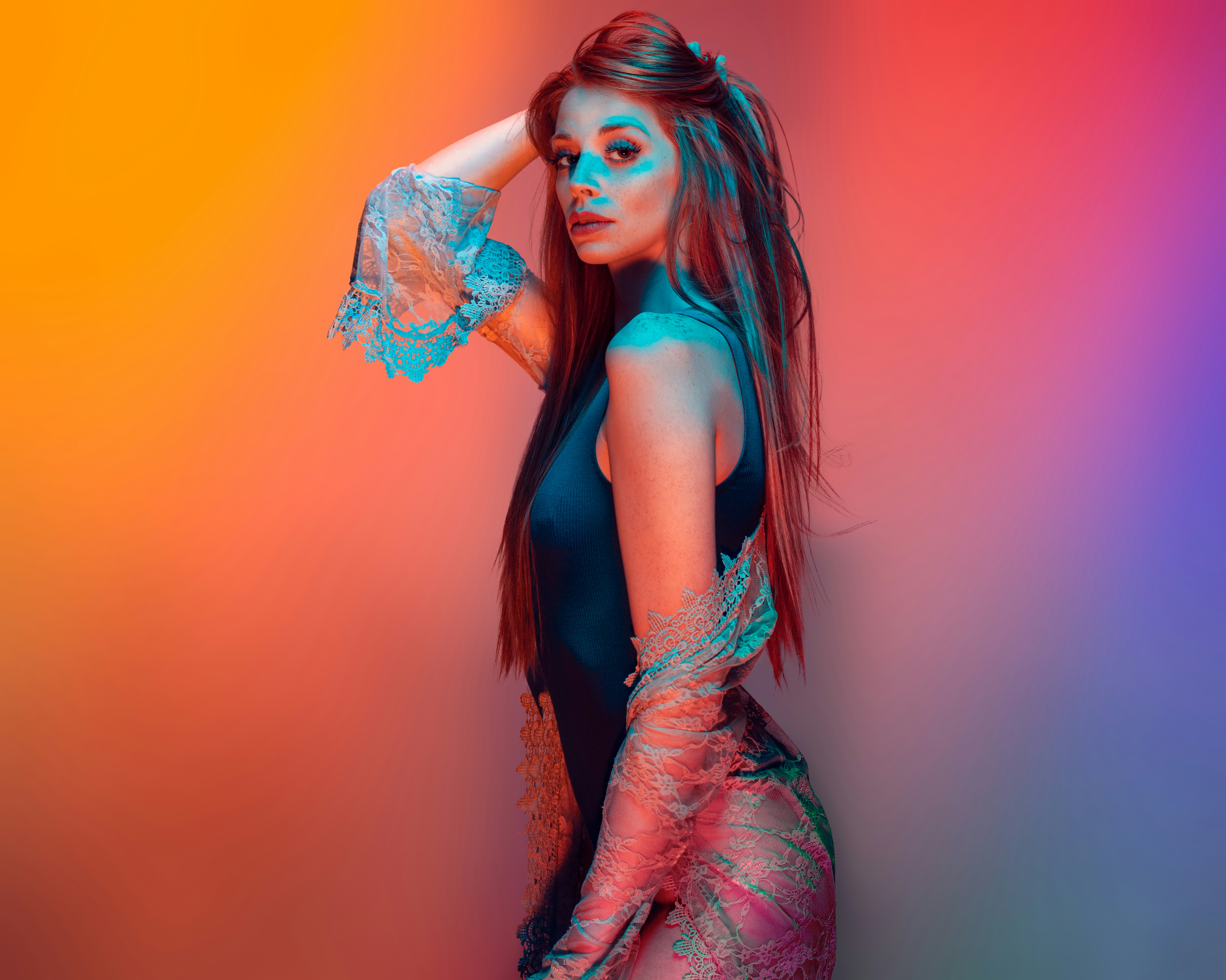 Woman posing with colorful gradient background