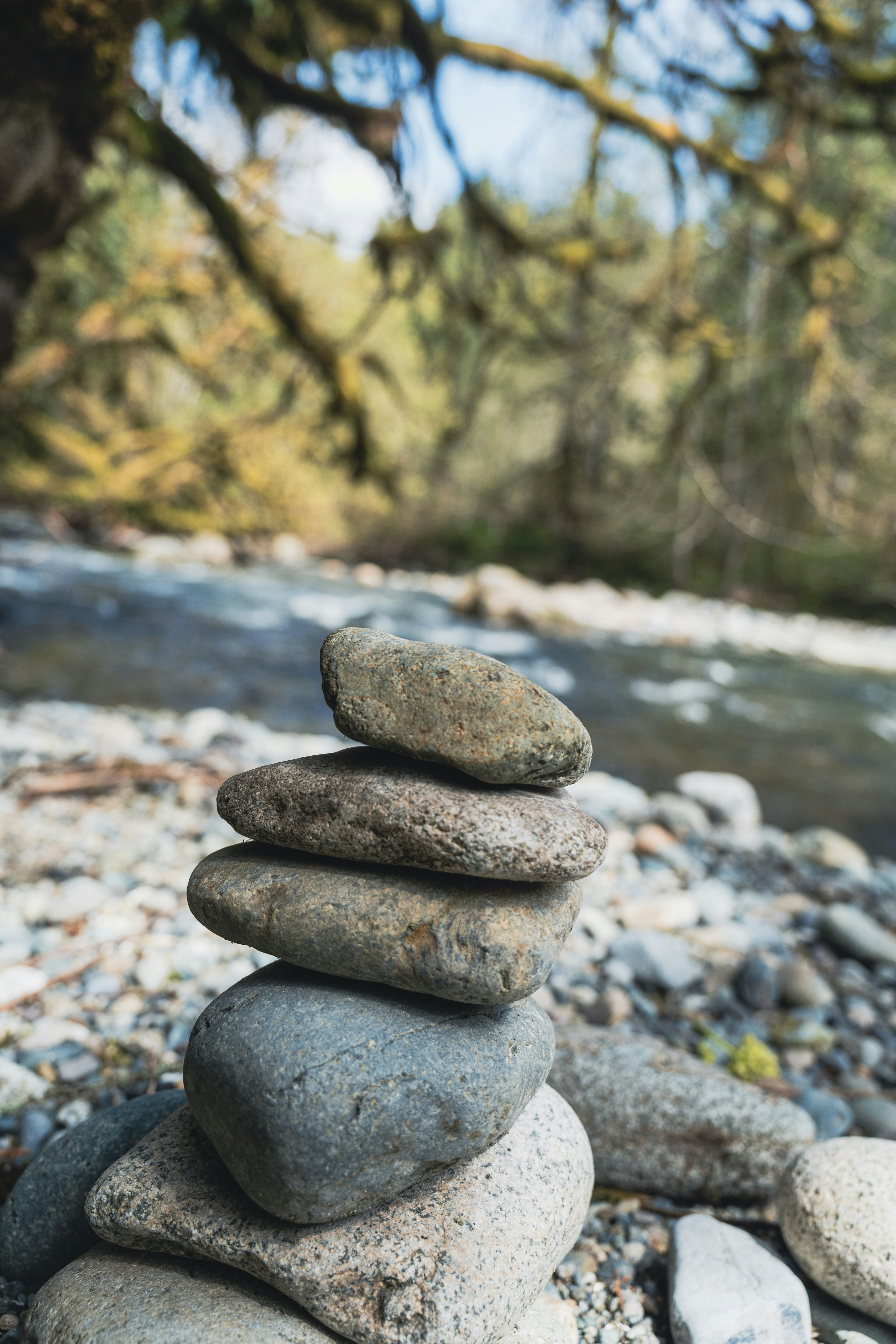 Stack of balanced stones by a flowing river