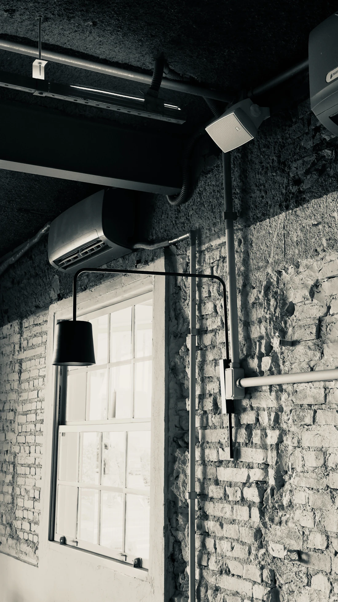 Exposed brick and steel-pipe industrial interior of the converted Hive Workspace foundry floor