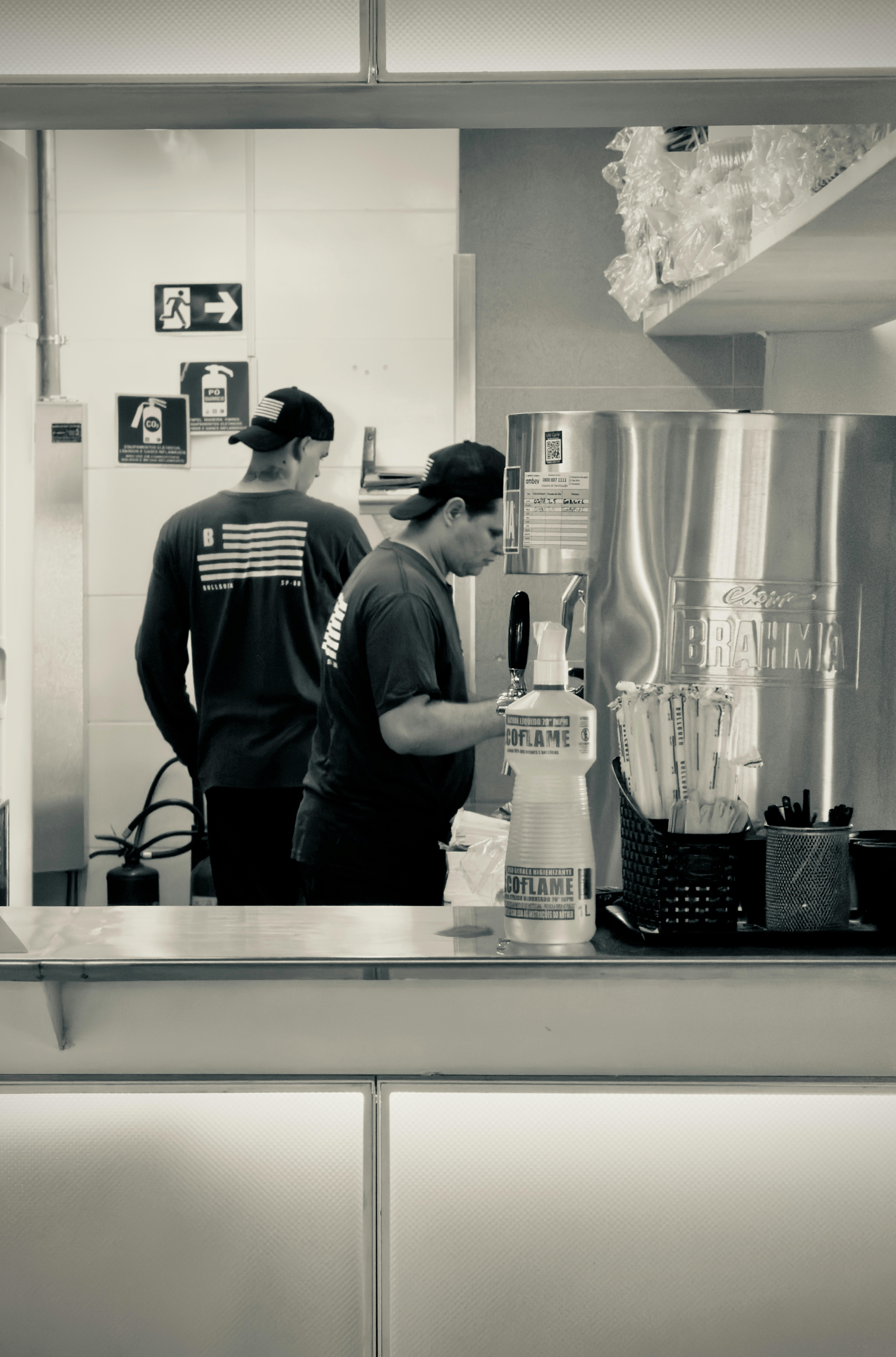 Two men working behind a counter