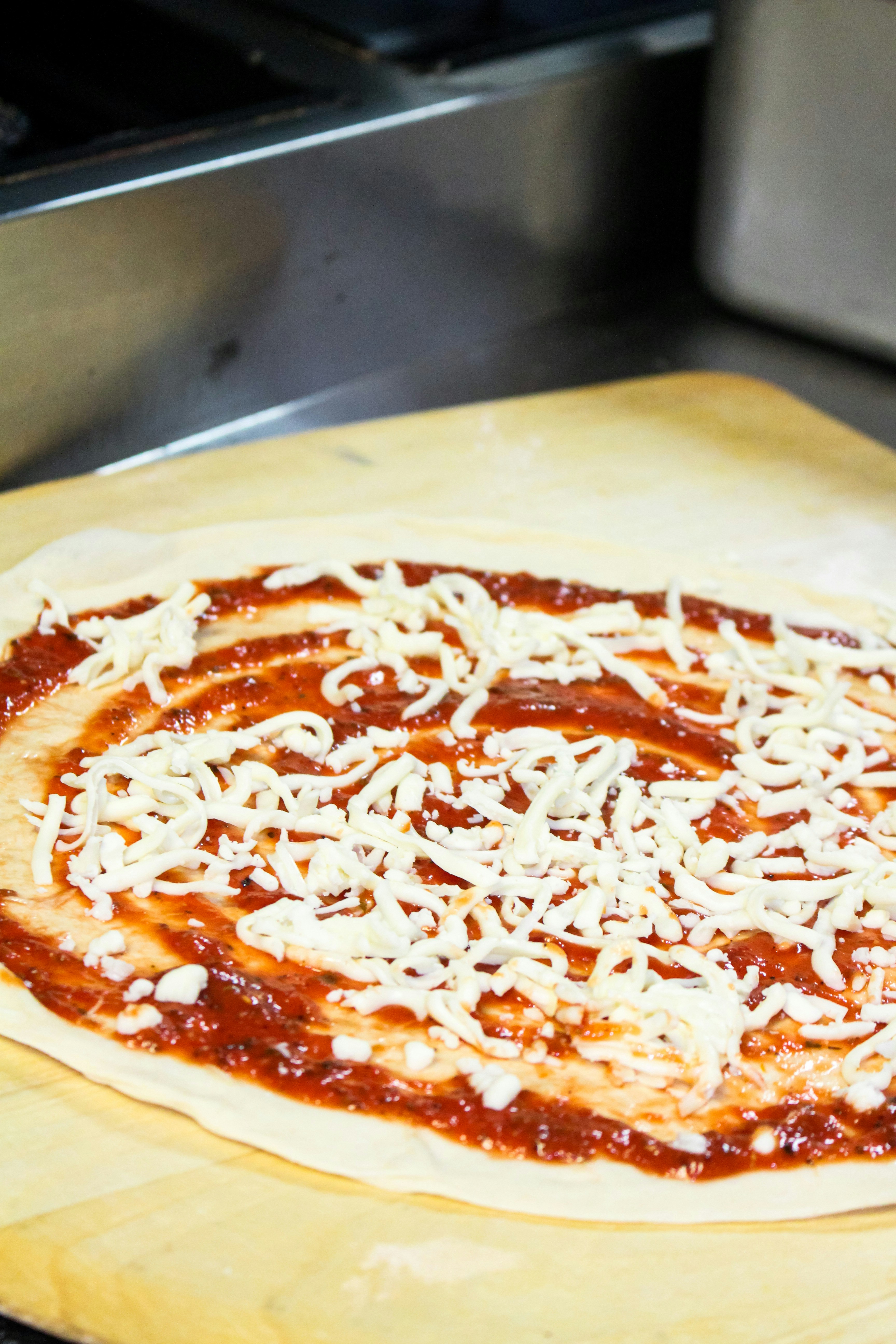 Pizza dough with tomato sauce and cheese