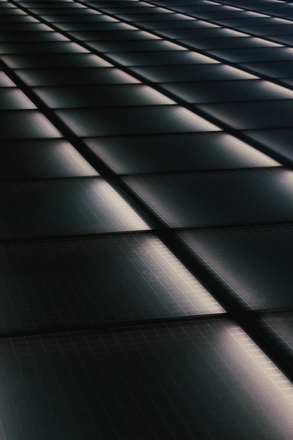 Close-up view of a grid-like pattern composed entirely of black squares with soft glow