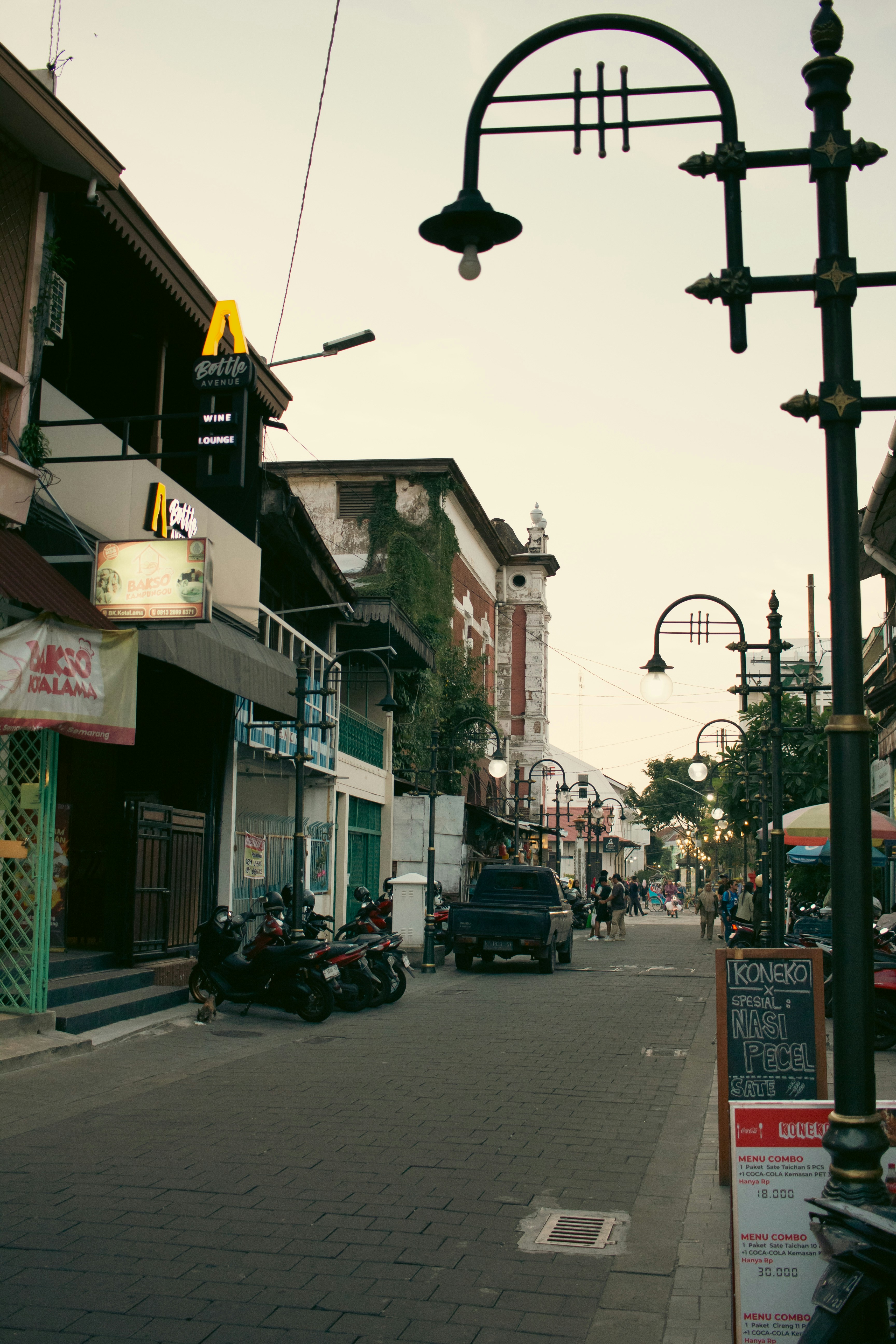 Street scene with shops and streetlights at dusk