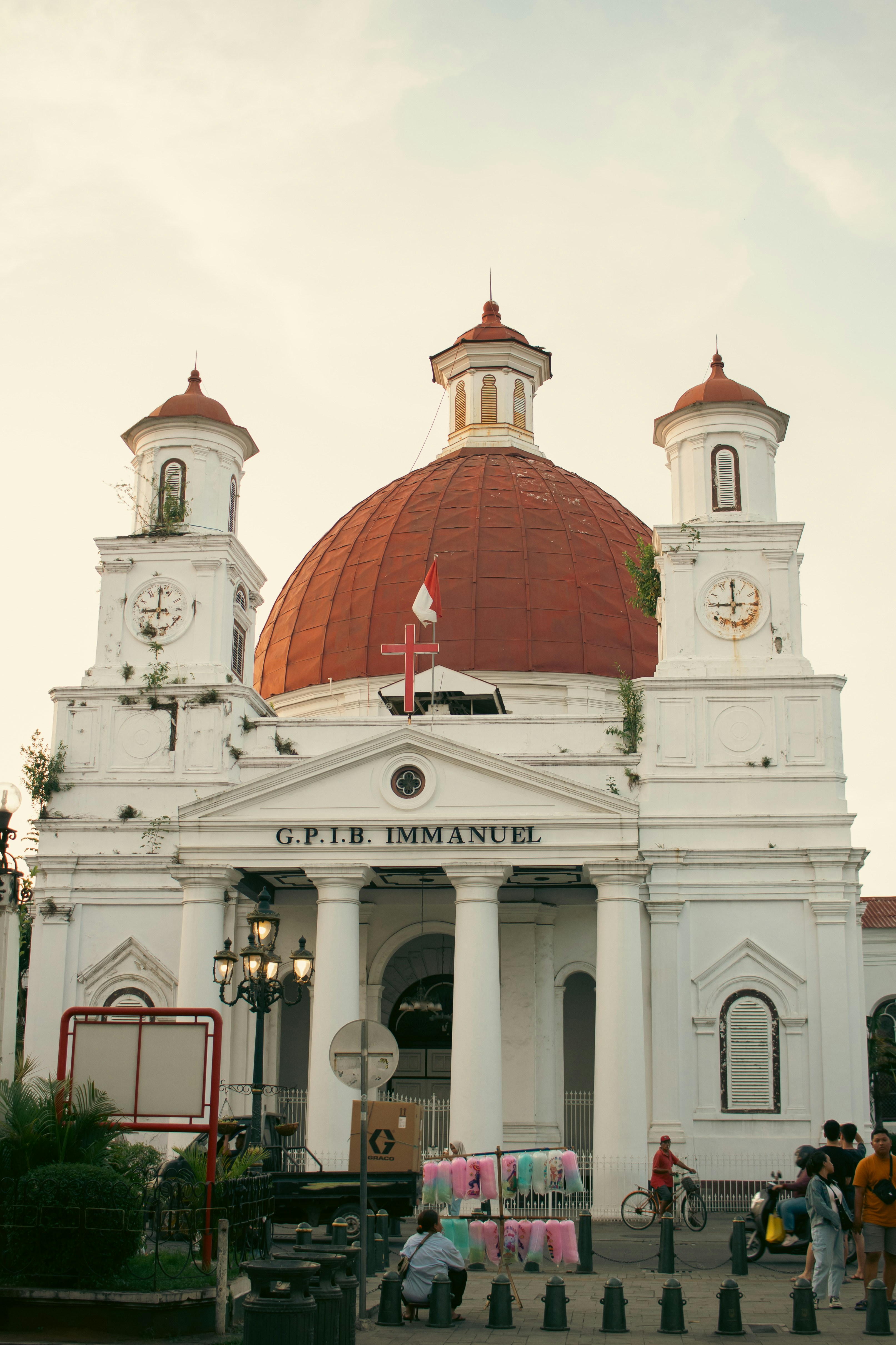 White church with a red dome and classical columns.