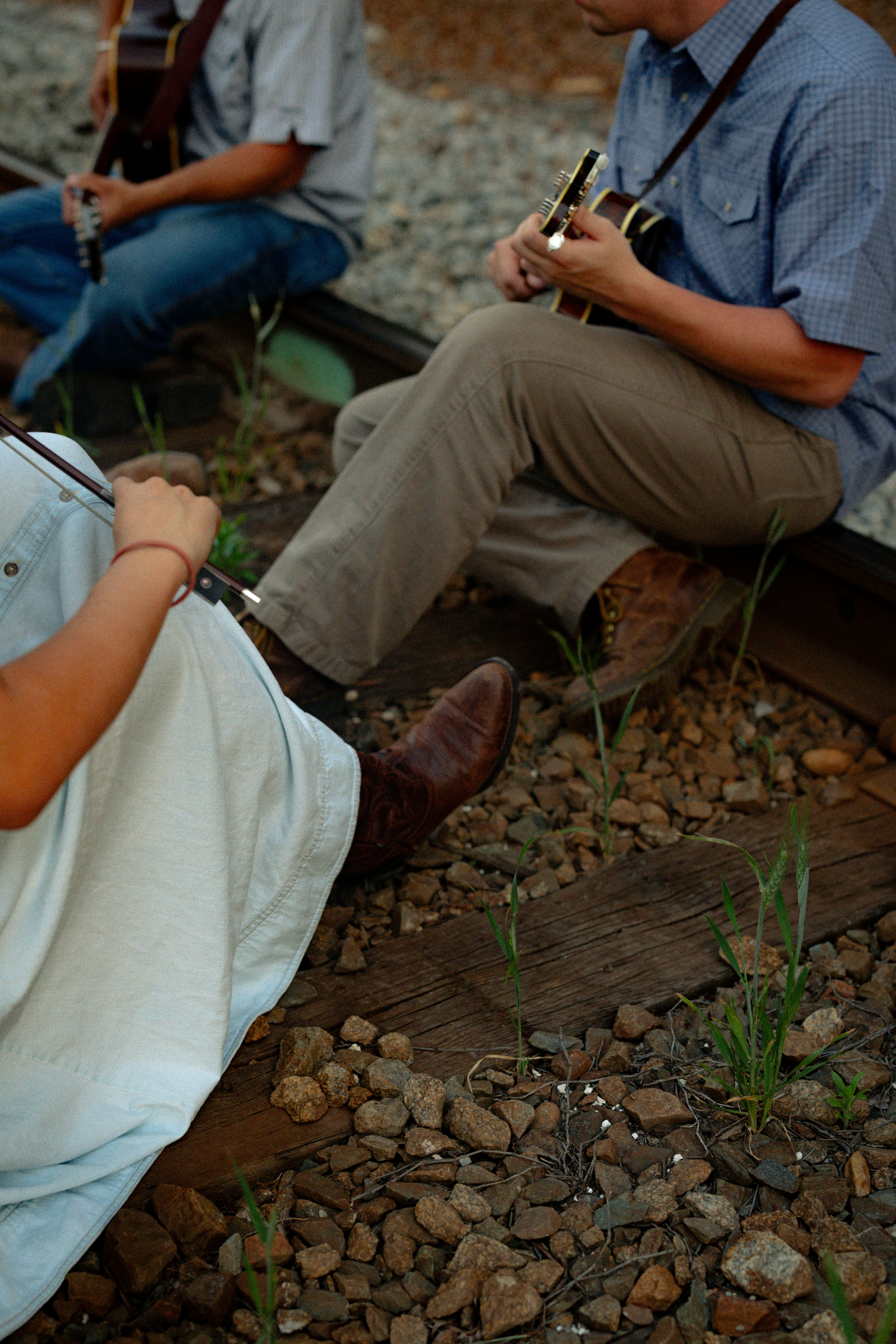 Musicians playing instruments on railroad tracks