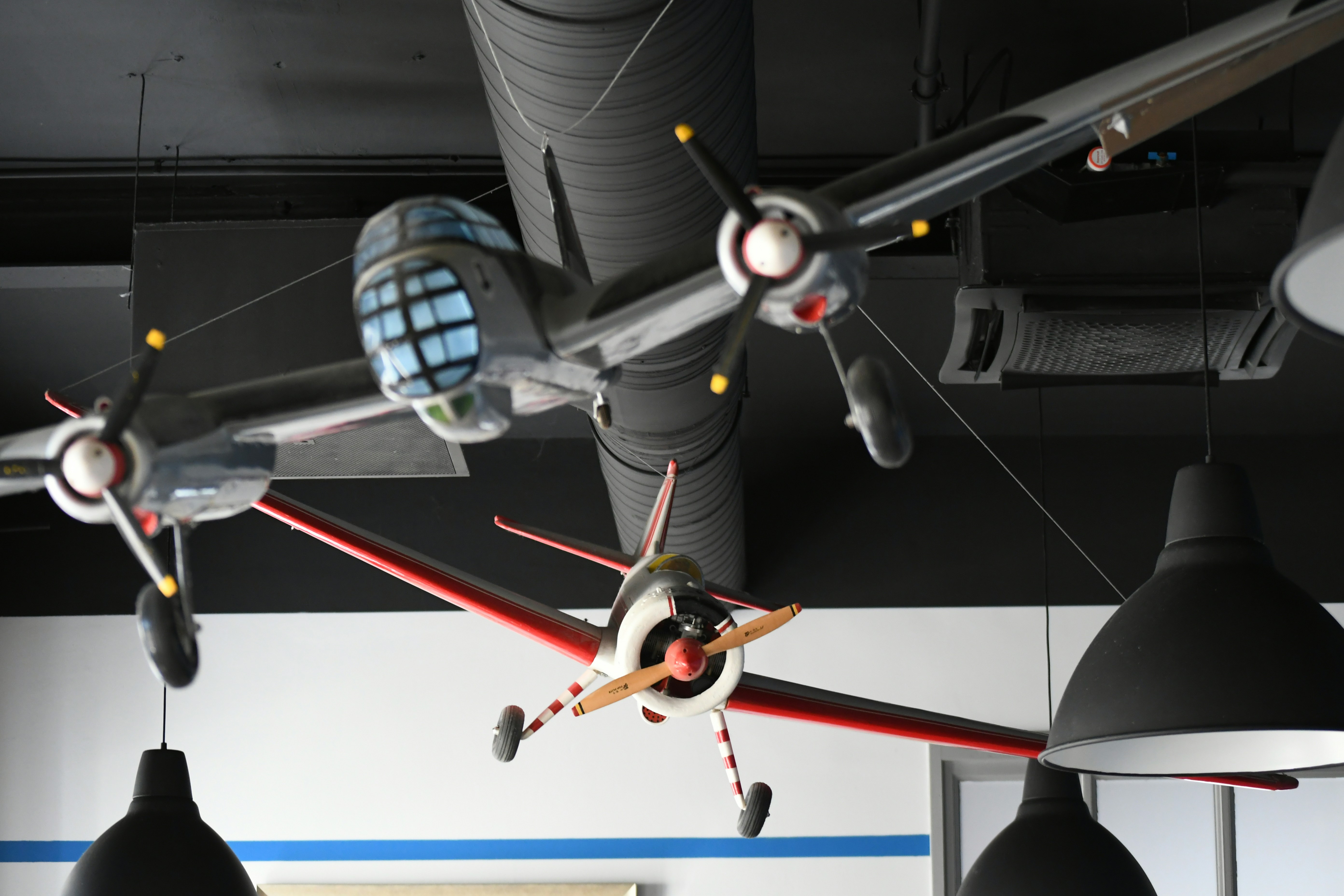 Three model airplanes hanging from ceiling