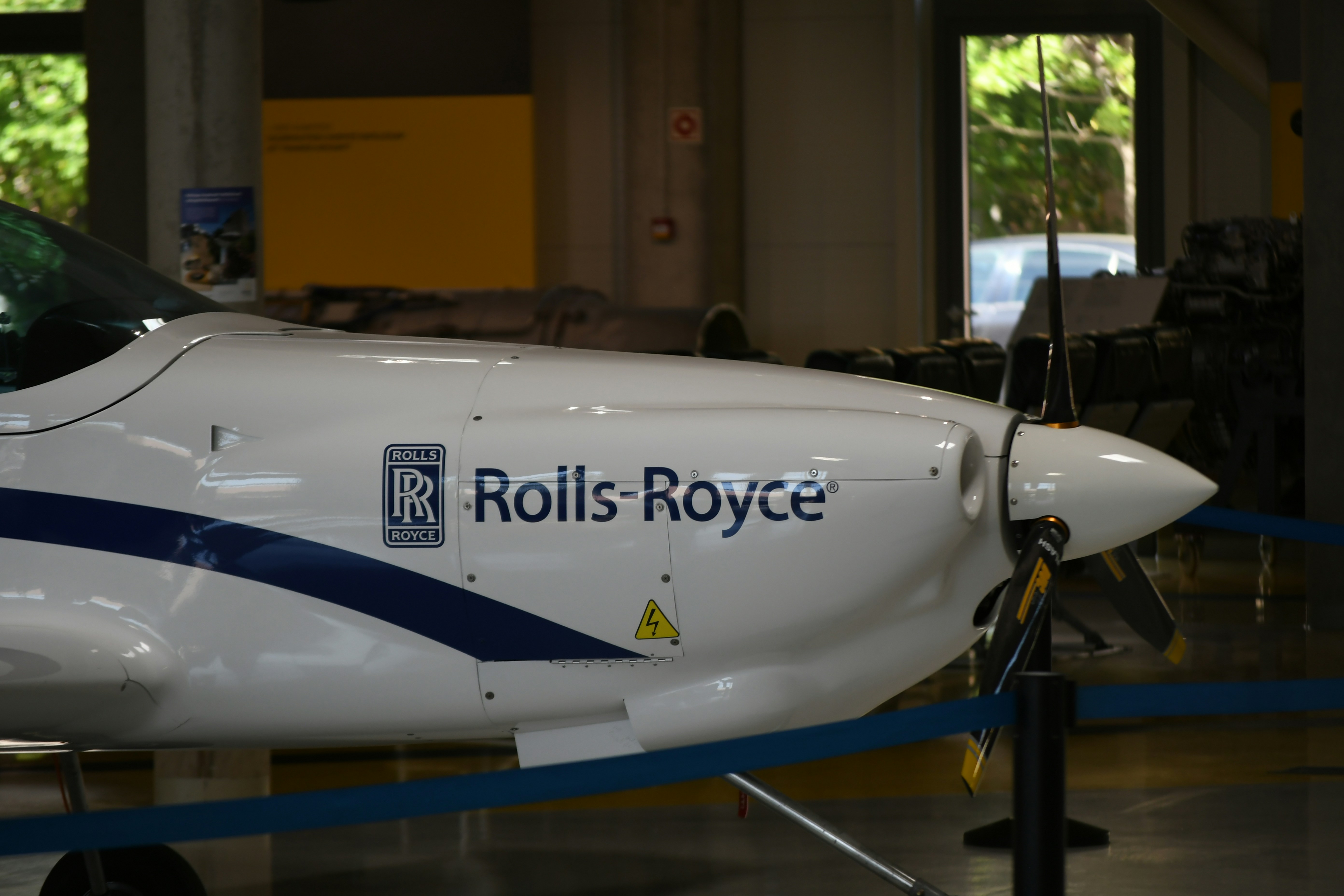White airplane with rolls-royce logo on fuselage.