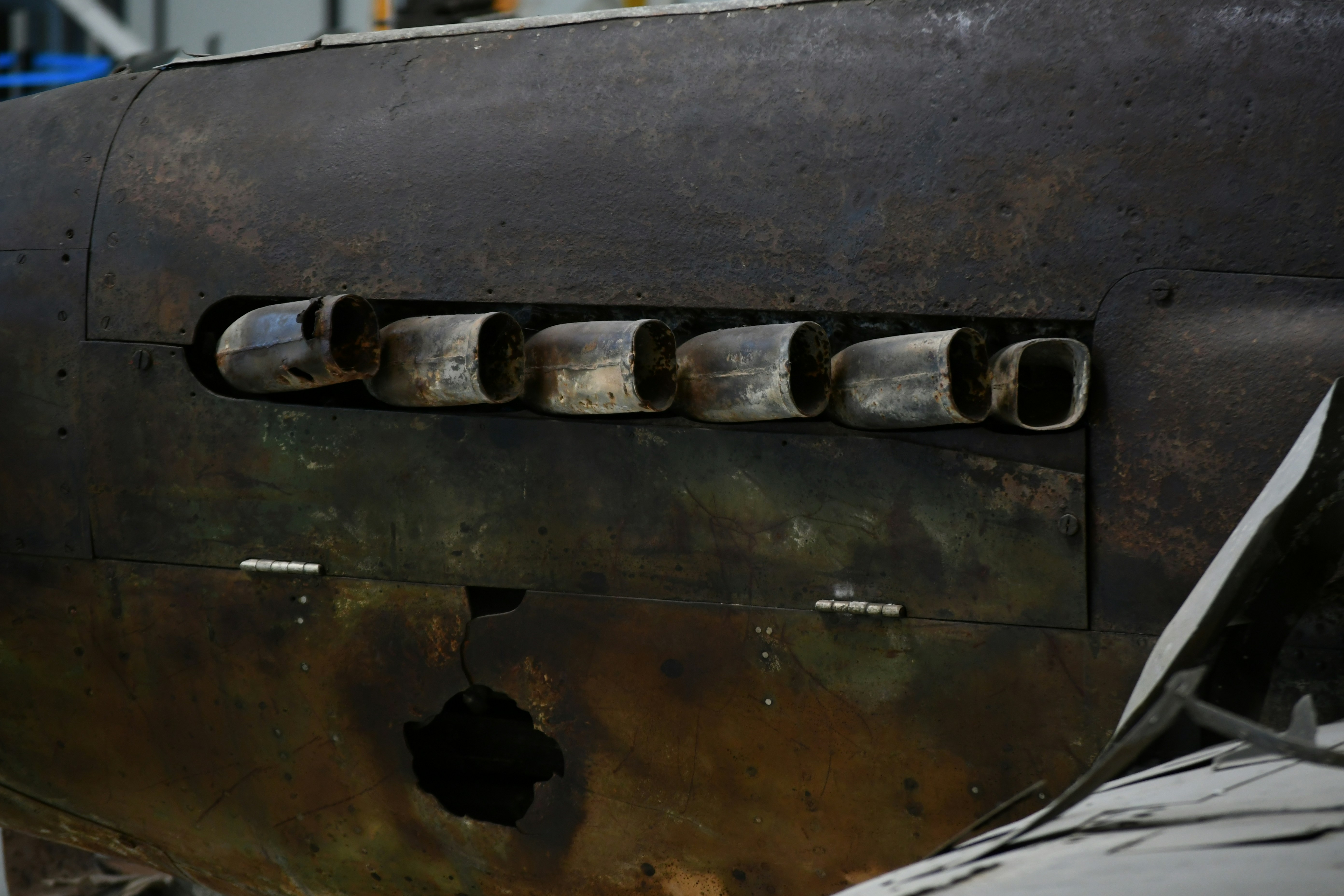 Close-up of exhaust pipes on a weathered aircraft