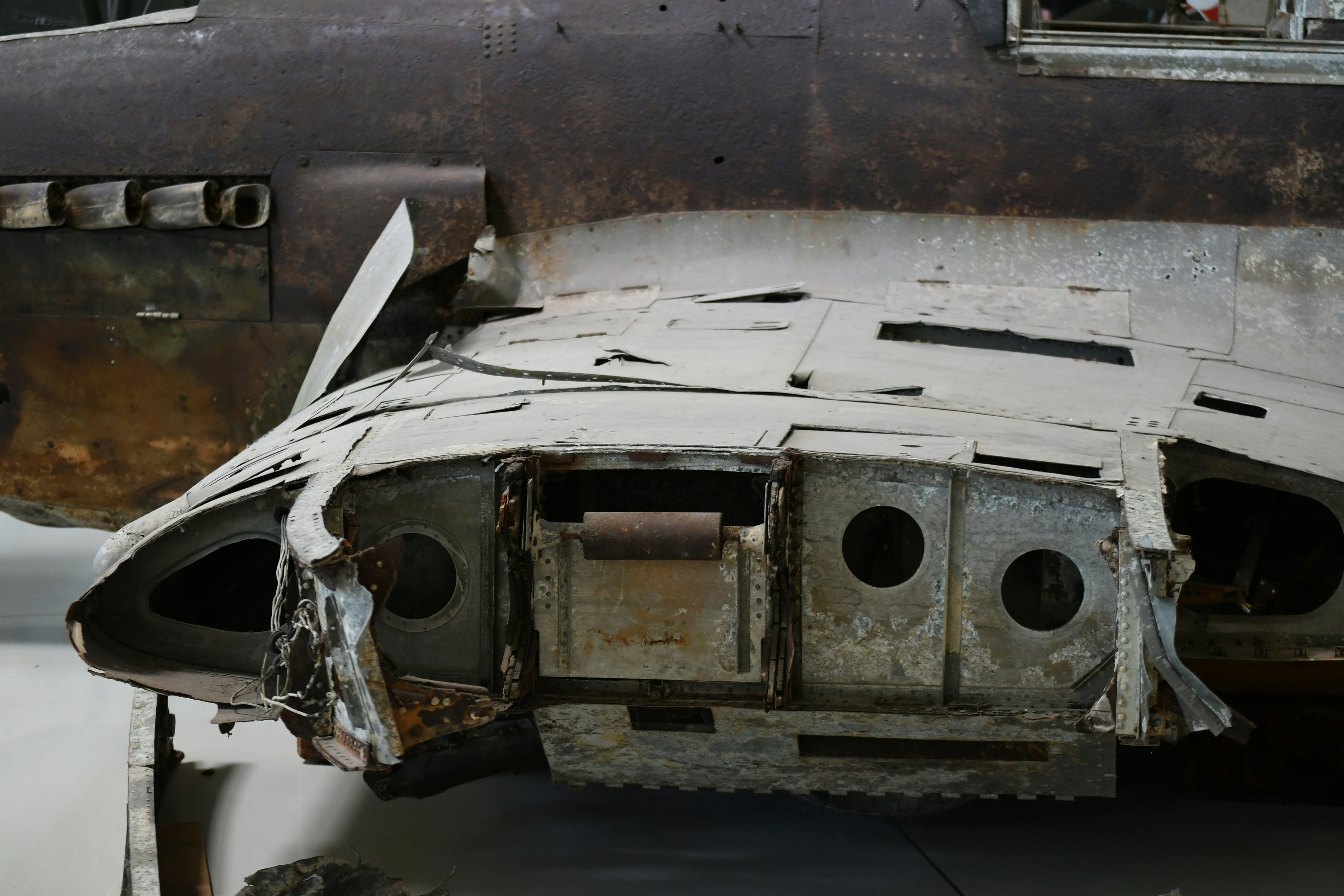 Damaged airplane fuselage with exposed metal components