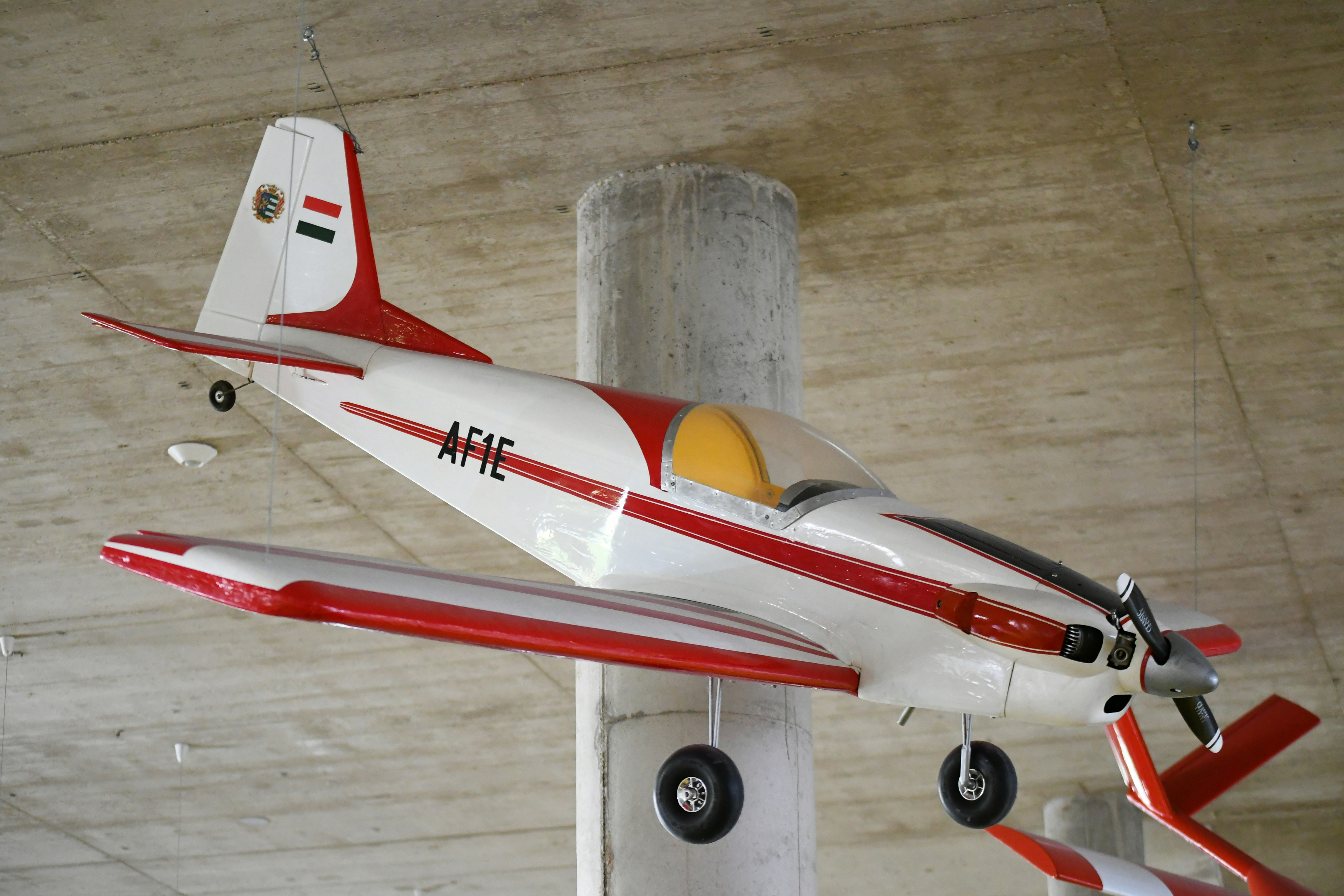 A white and red propeller airplane with markings.
