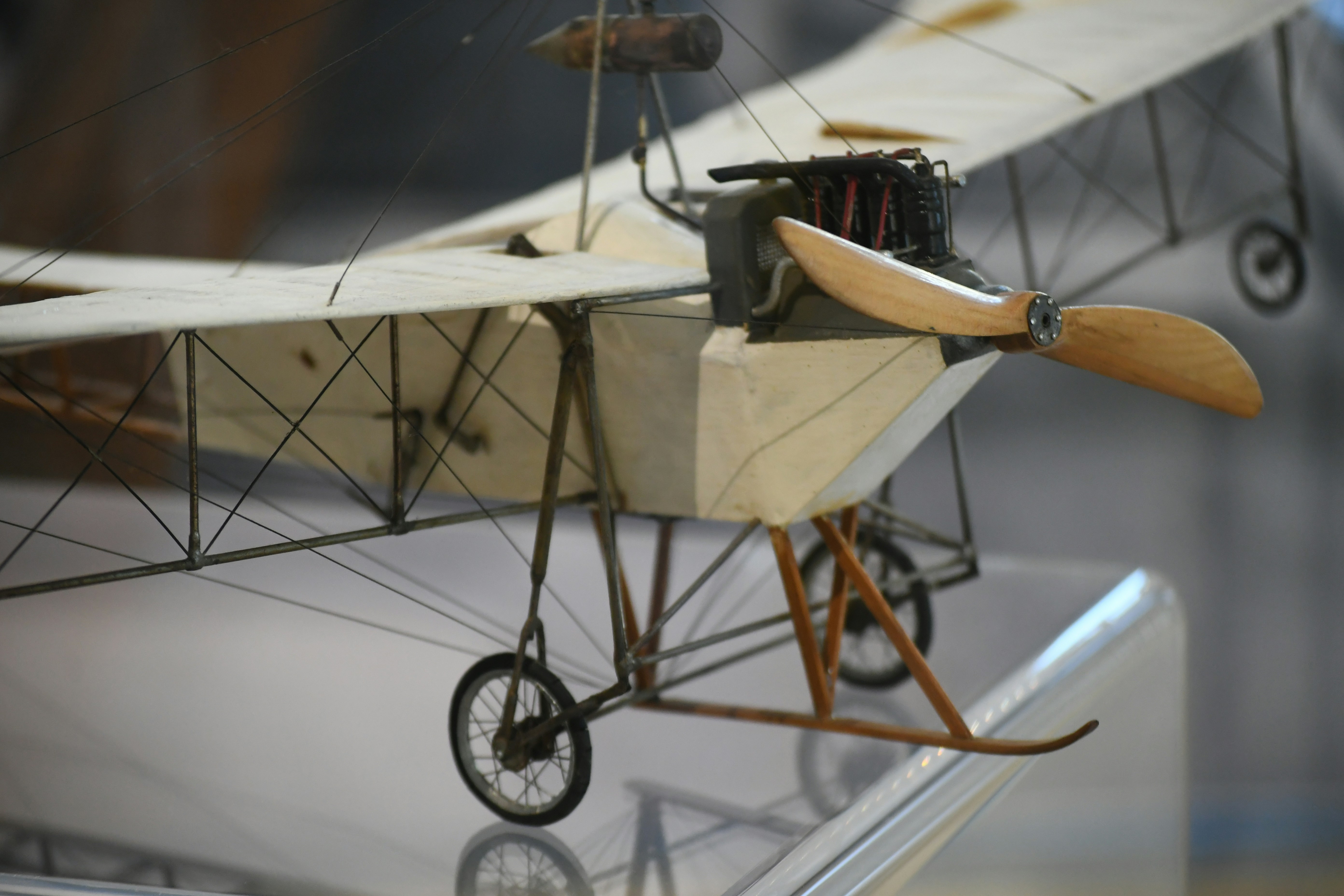 Close-up of a vintage biplane model with wooden propeller.