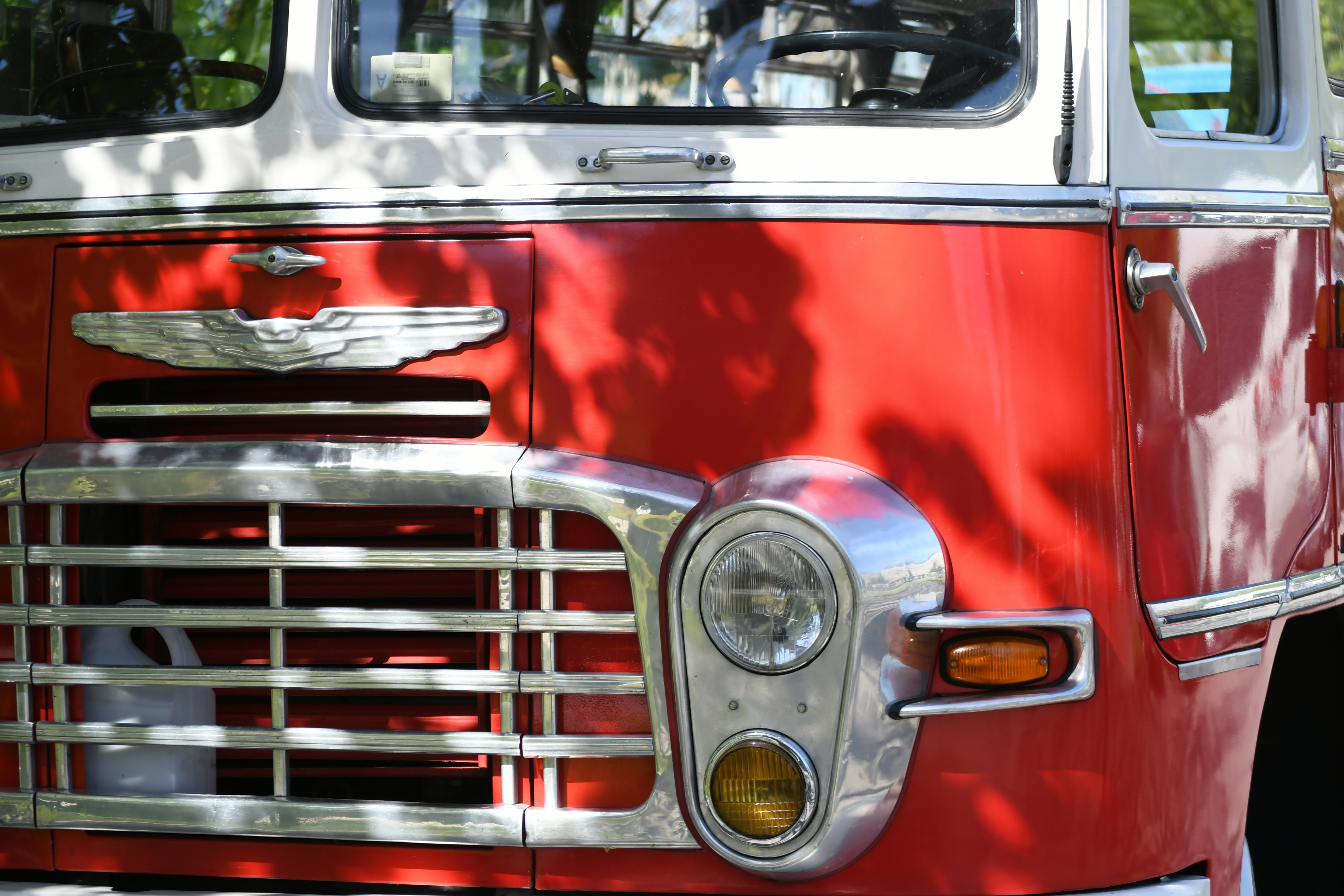 Close-up of a vintage red fire truck grille.