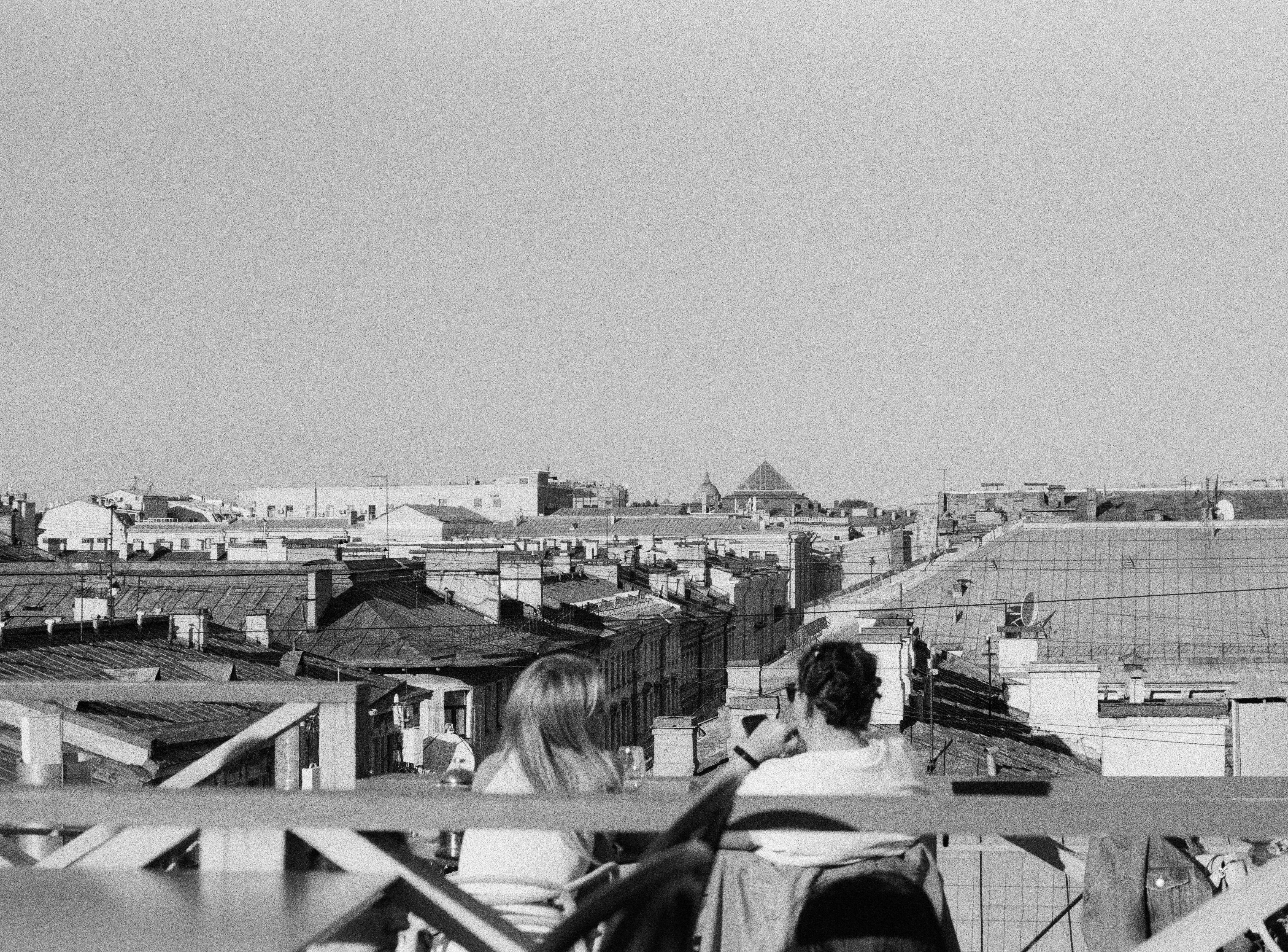 Resident working on a sun-drenched rooftop terrace with a laptop - coworking apartments North Park