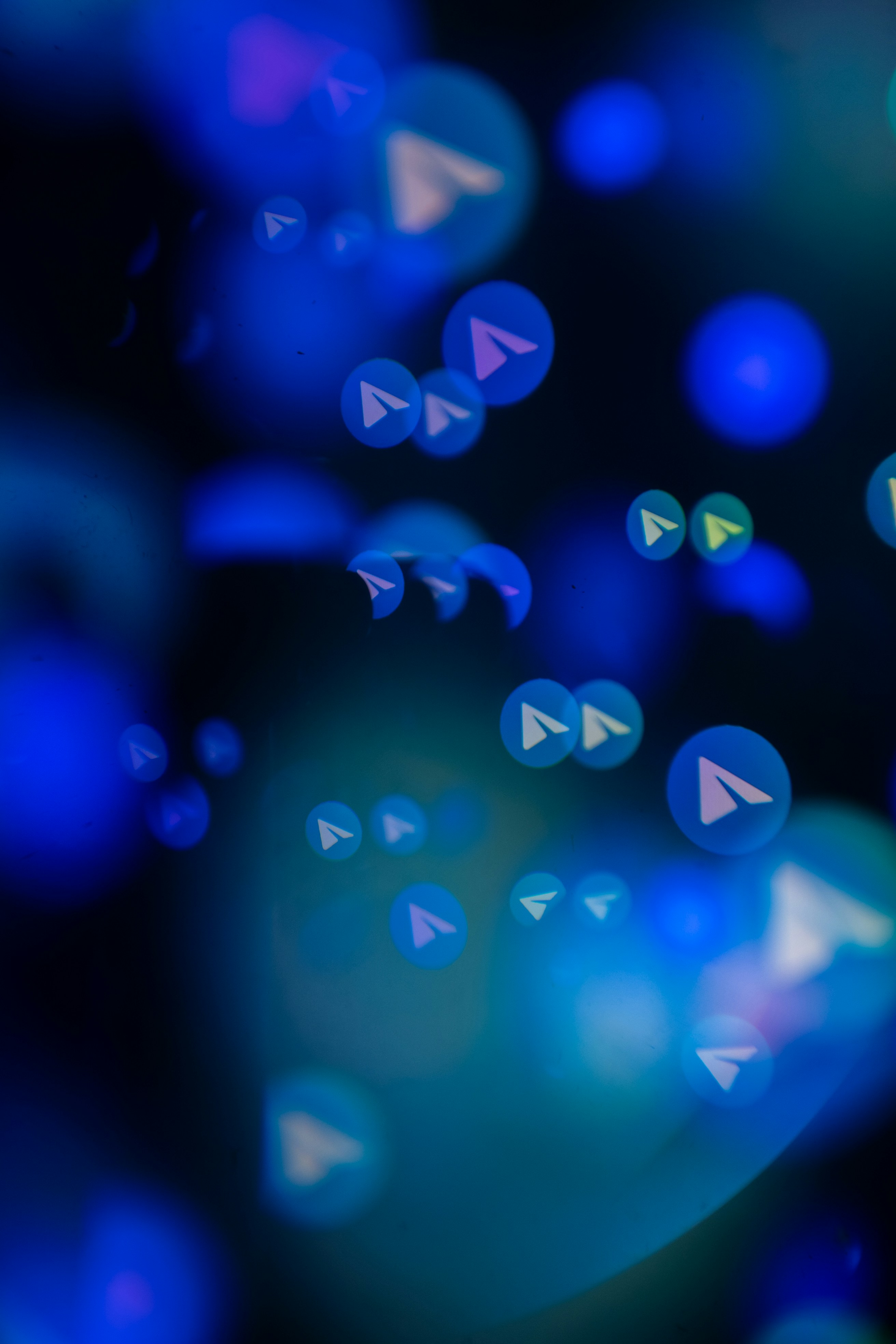 Abstract blue bokeh lights with paper airplane icons