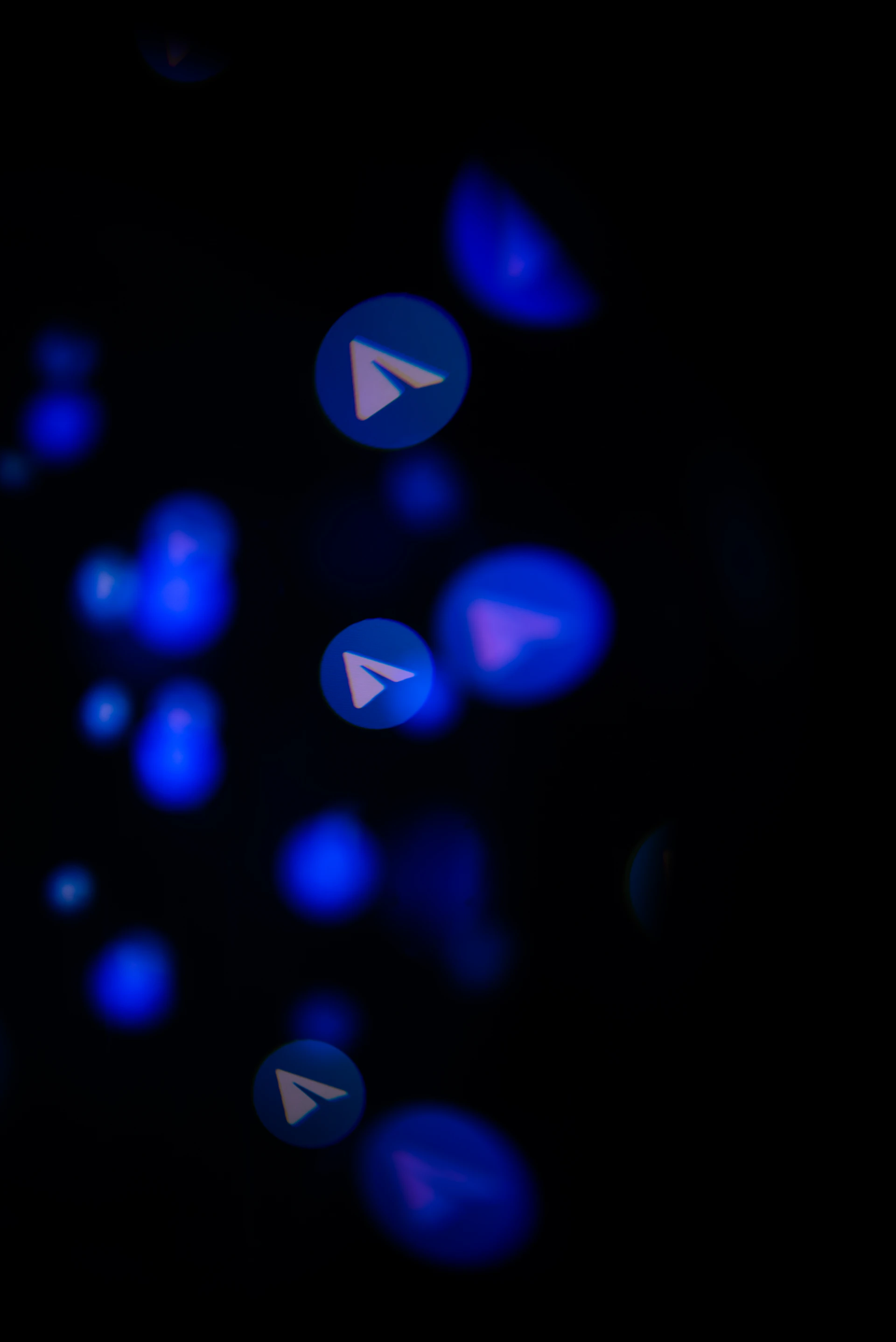 Telegram logo icons in blue bokeh lights