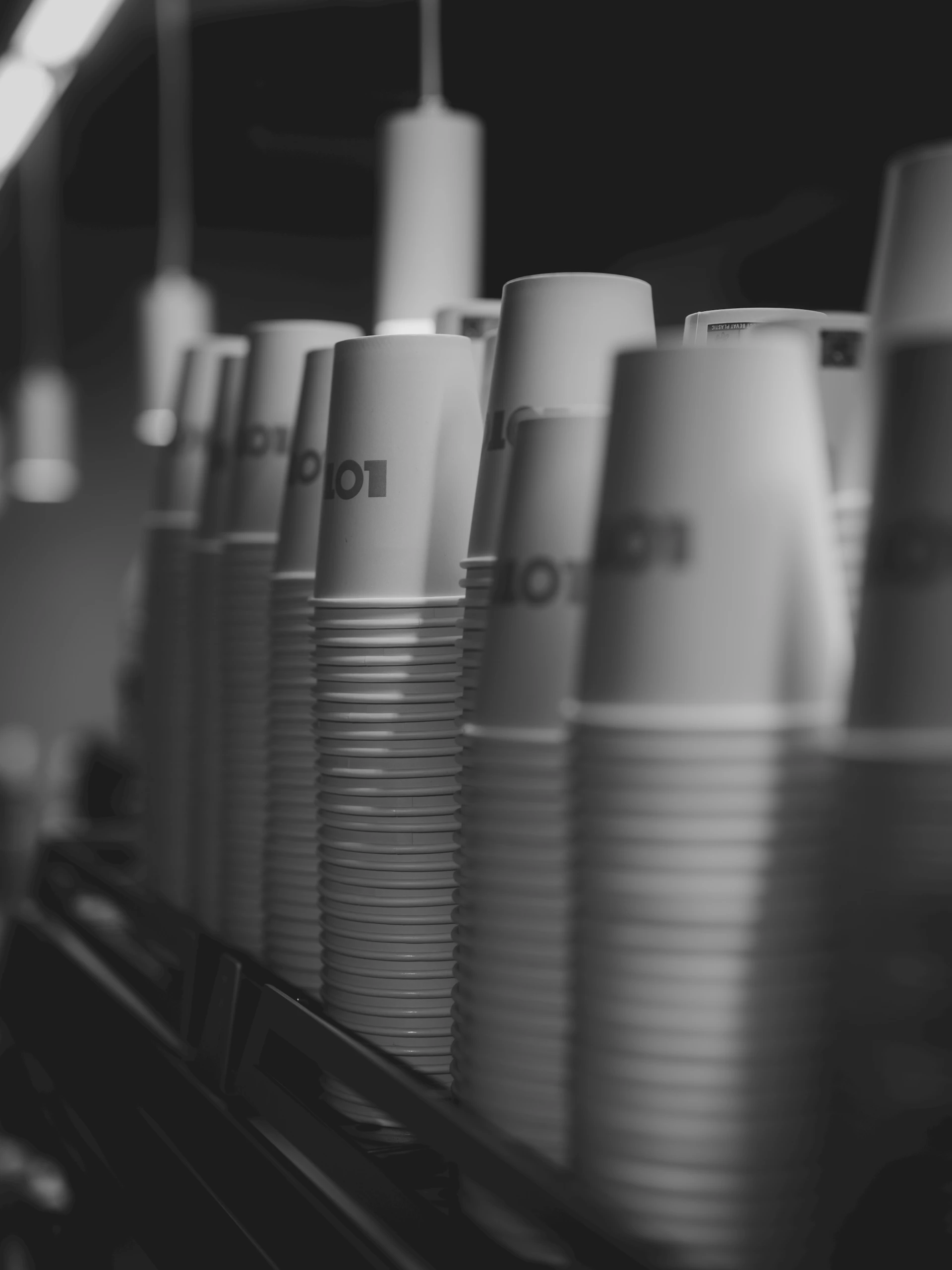 A row of stacked paper cups with logos