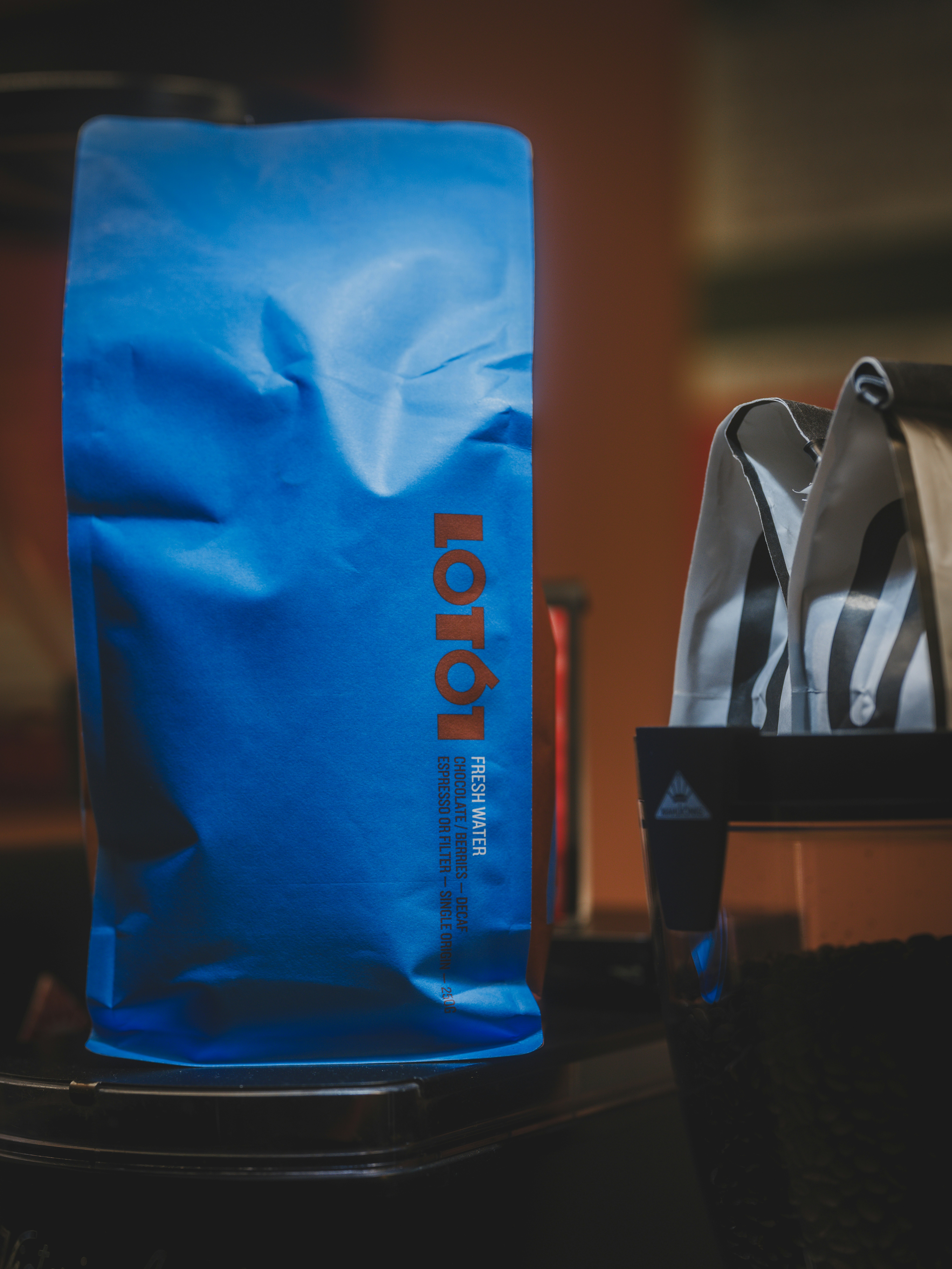 A blue bag with orange lettering sits on a surface