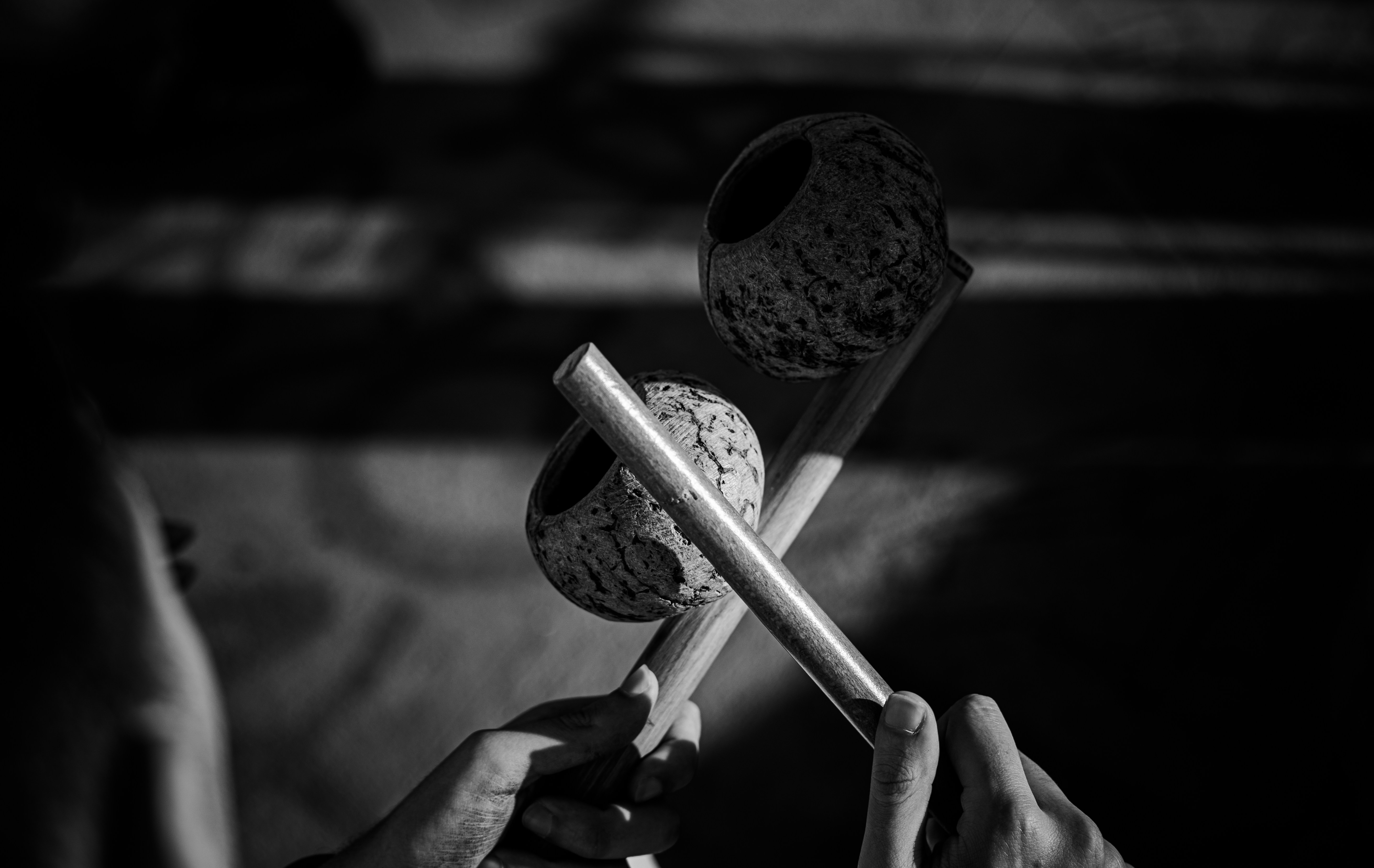 Two hands holding traditional percussion instruments