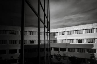 Modern building with reflective glass windows and sky.