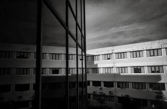 Modern building with reflective glass windows and sky.