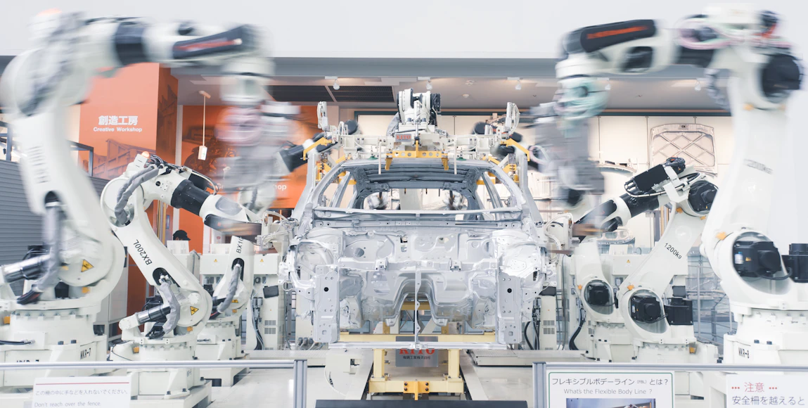 Robotic arms assembling a vehicle chassis
