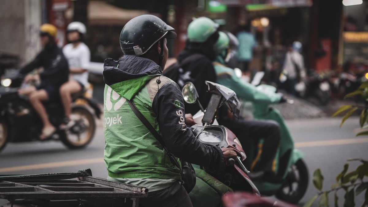 Smartphone locked in a handlebar mount on a motorcycle cockpit while riding in traffic