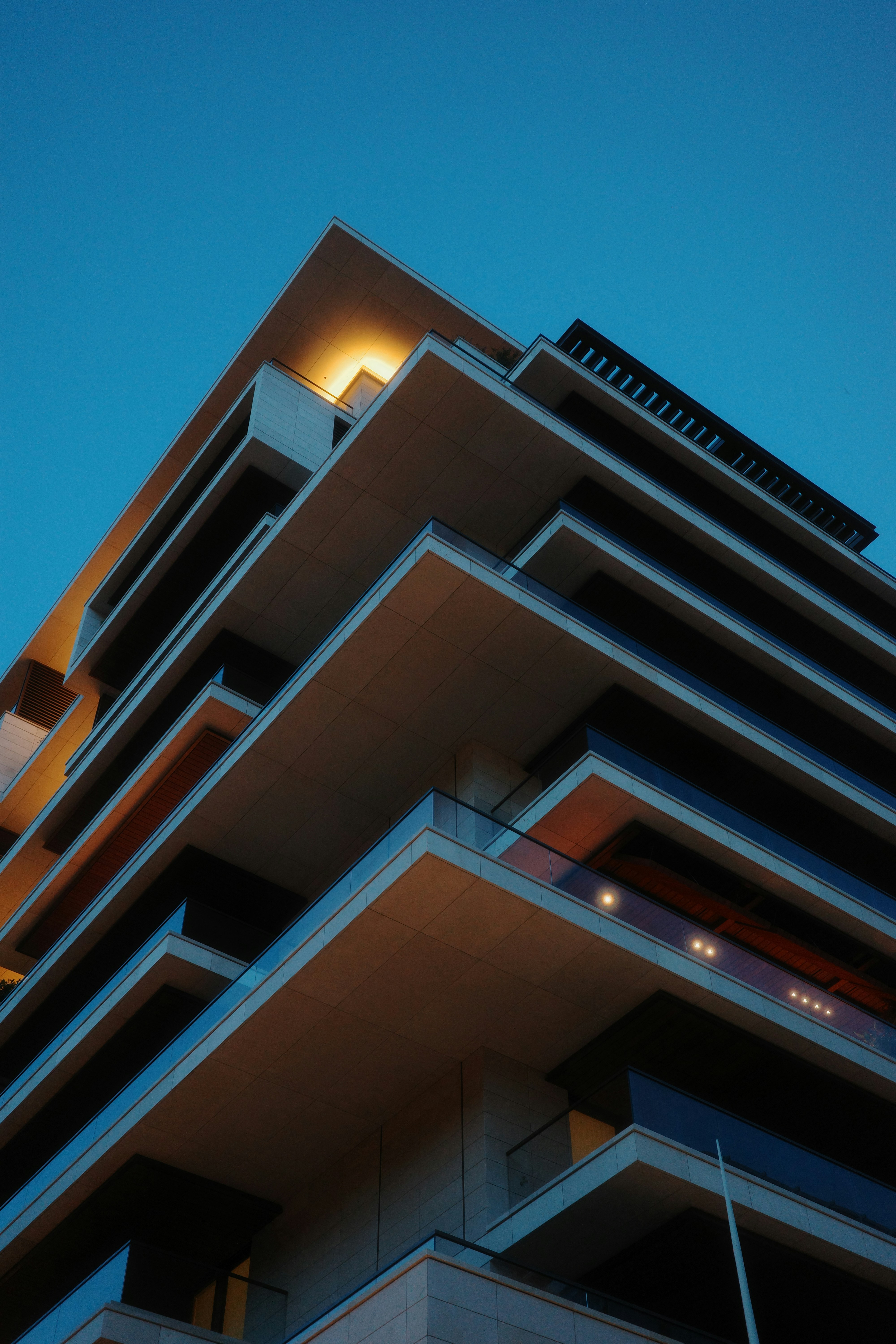 Modern building with layered balconies at dusk