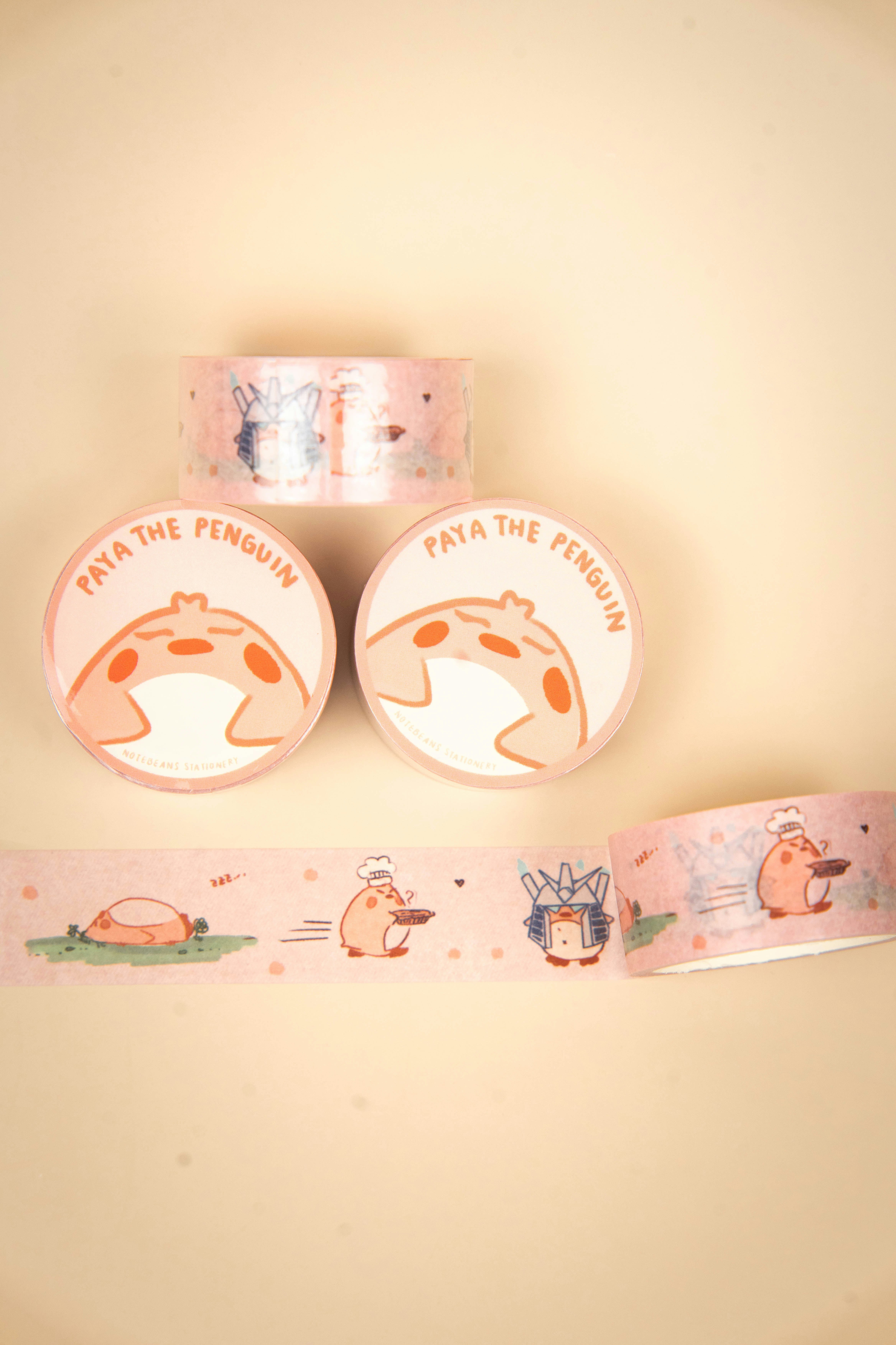 Rolls of pink decorative tape with penguin designs.