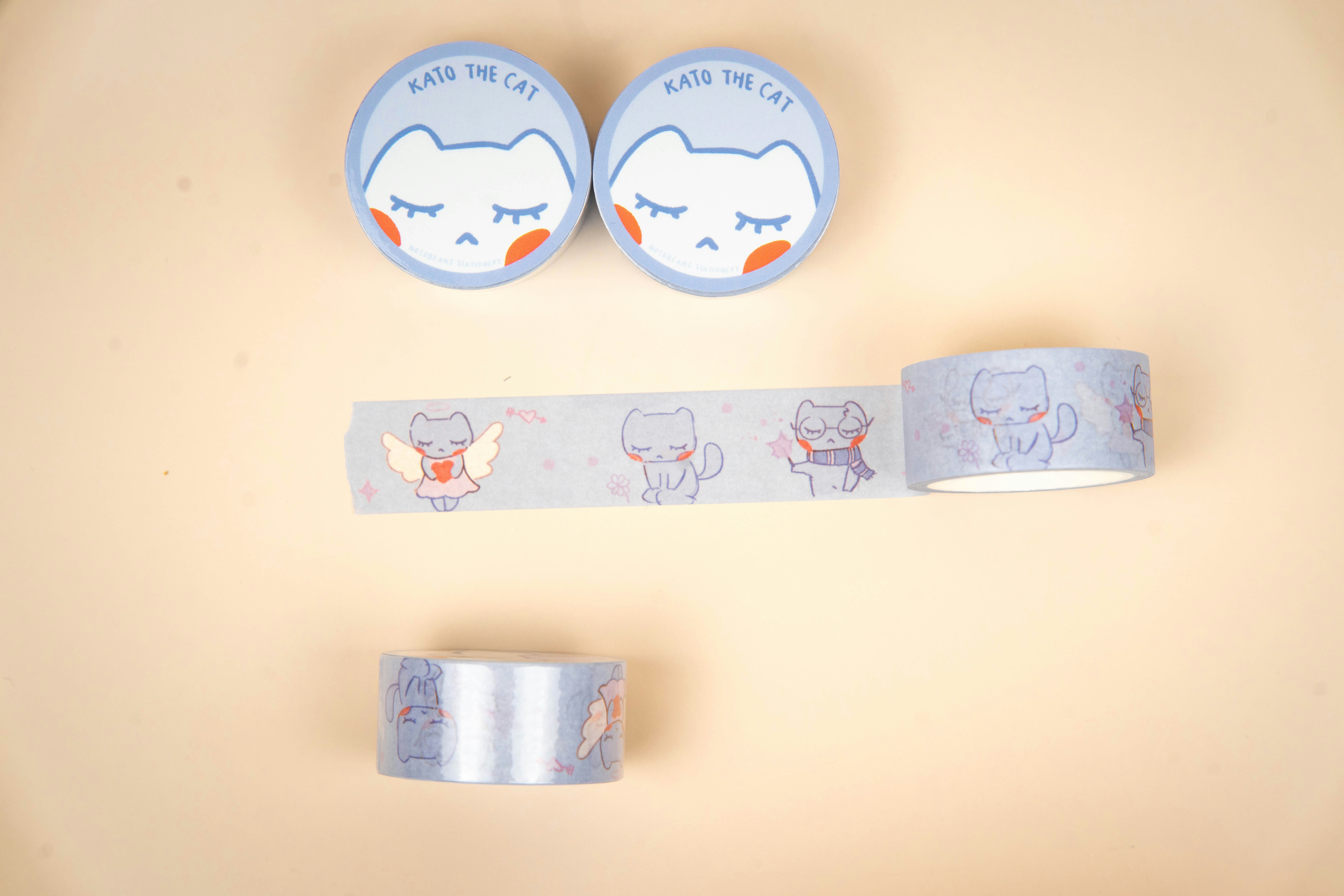 Two rolls and a strip of cat-themed washi tape.