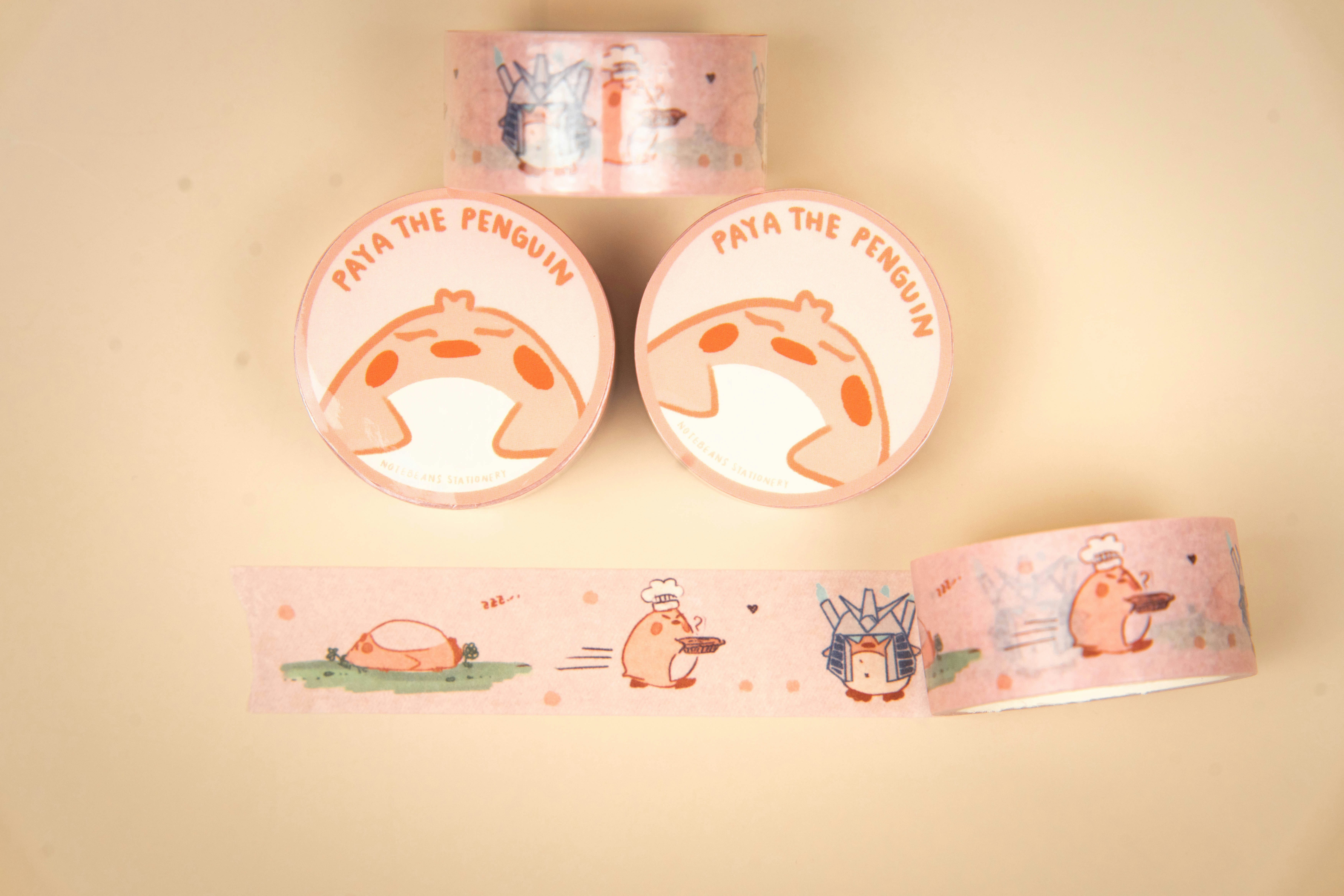 Rolls of pink decorative tape with penguin designs.