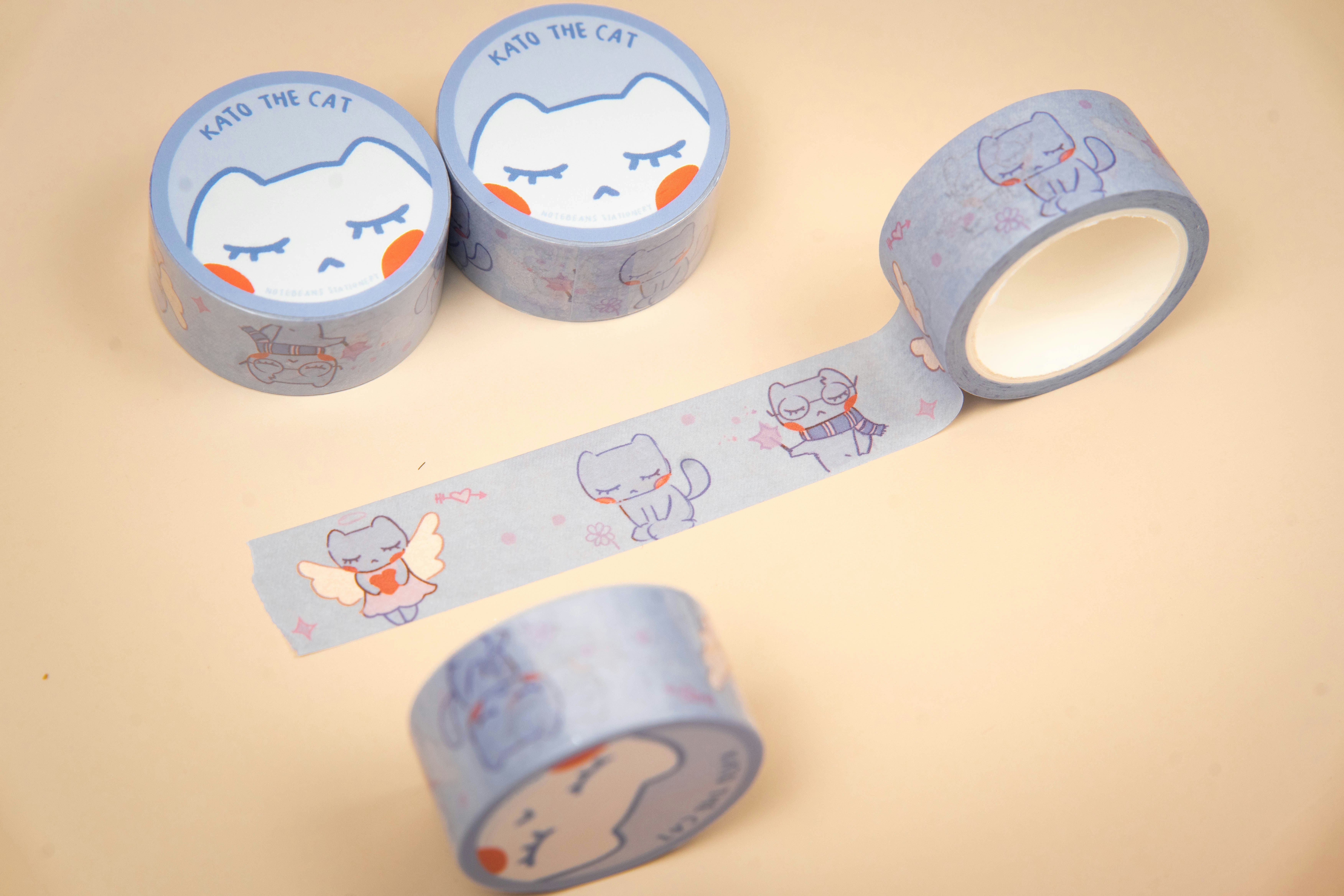 Rolls of light blue decorative tape with cat designs.
