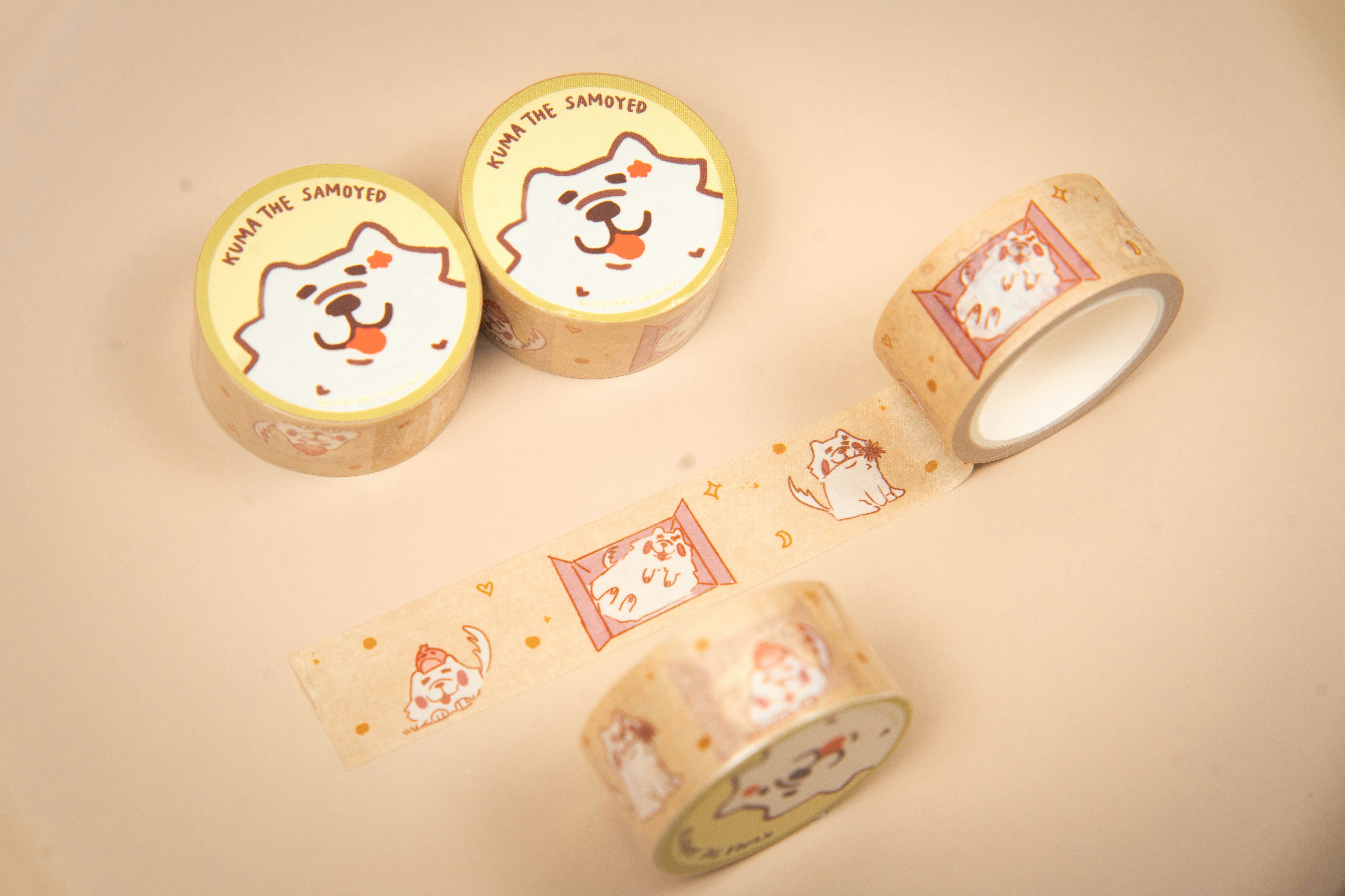 Rolls of cute dog patterned tape on a light background.