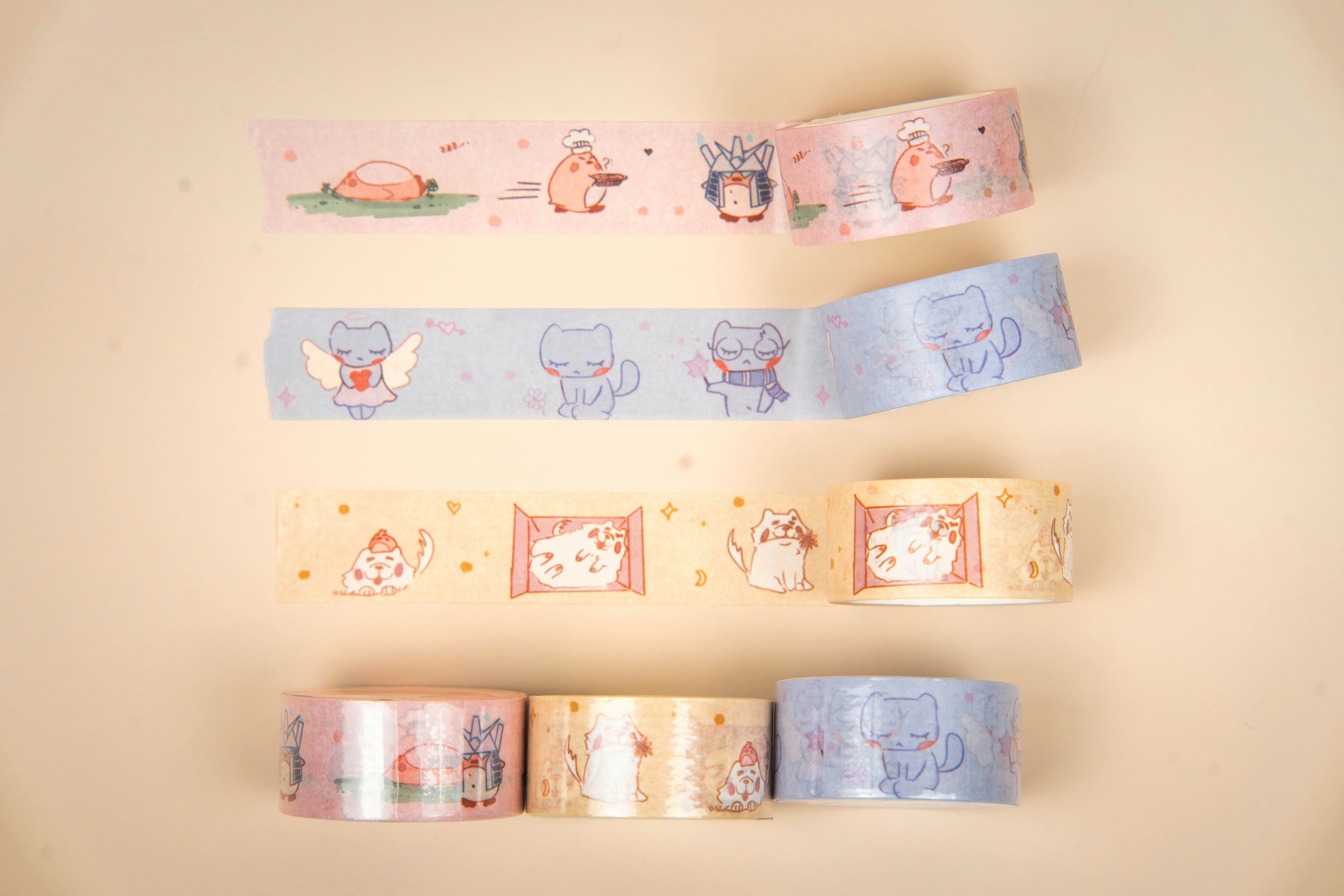 Four rolls of decorative tape with cute designs.