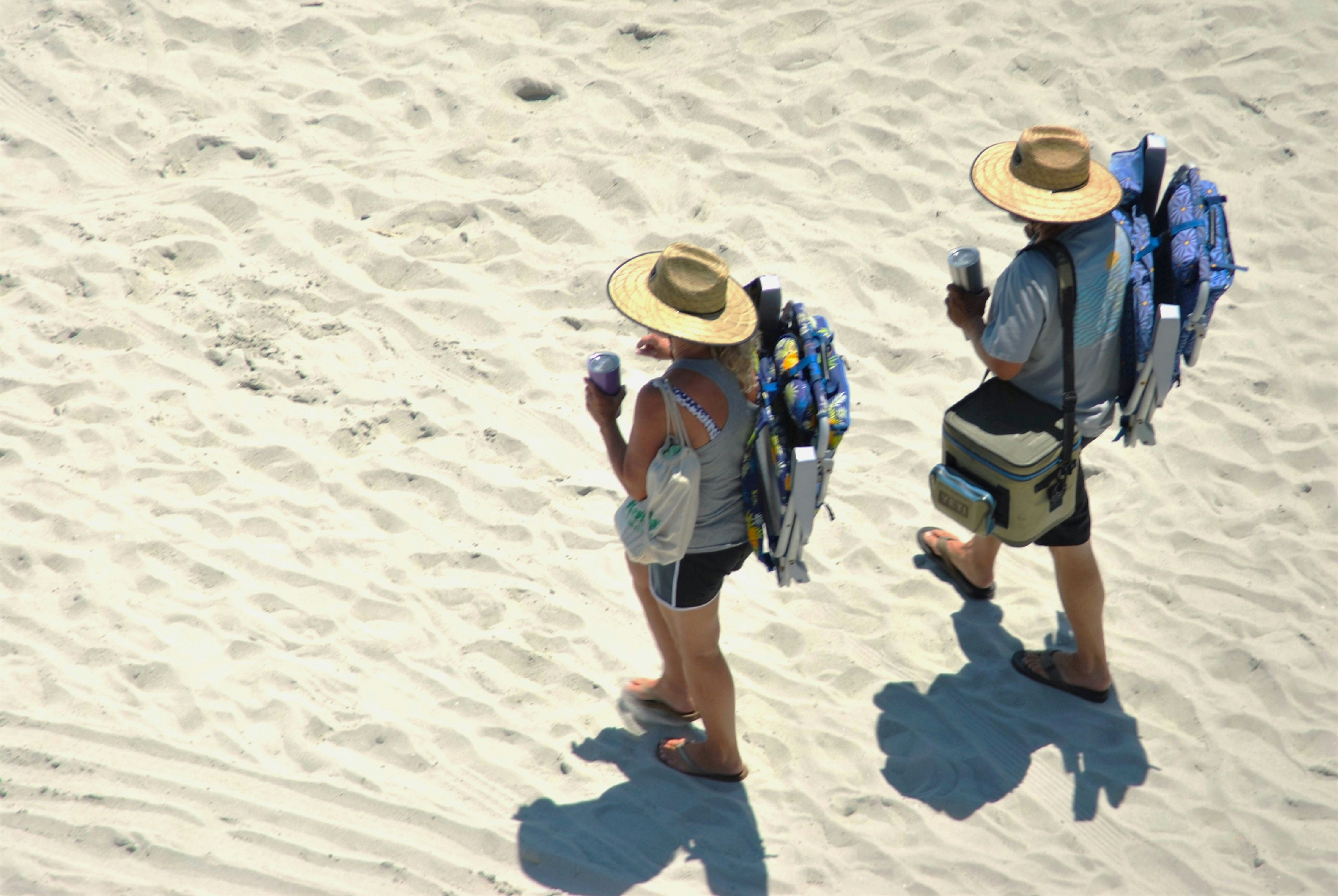 Deux personnes marchant sur une plage de sable