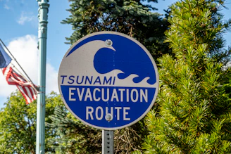 Tsunami evacuation route sign with waves