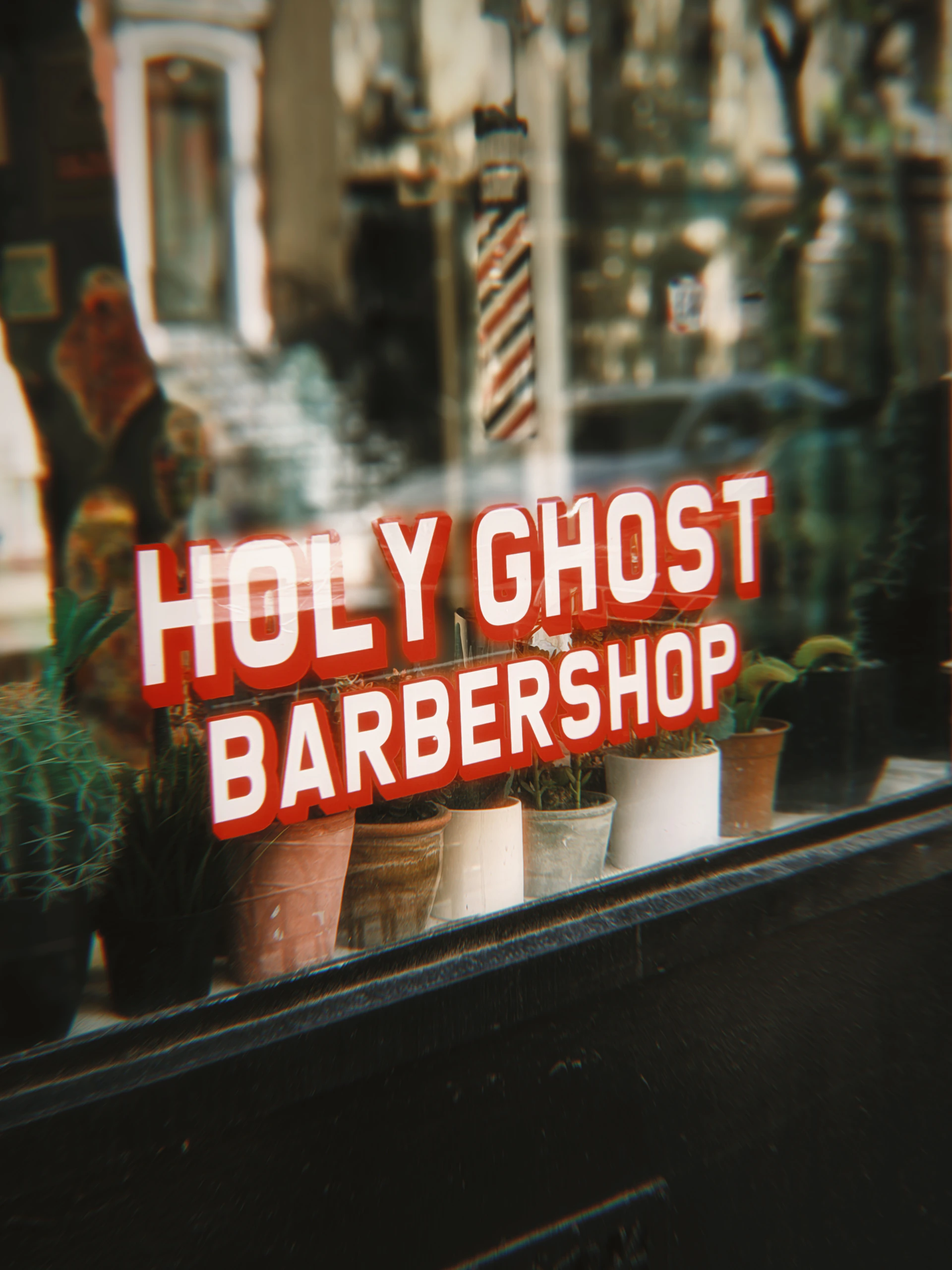Holy ghost barbershop sign with plants