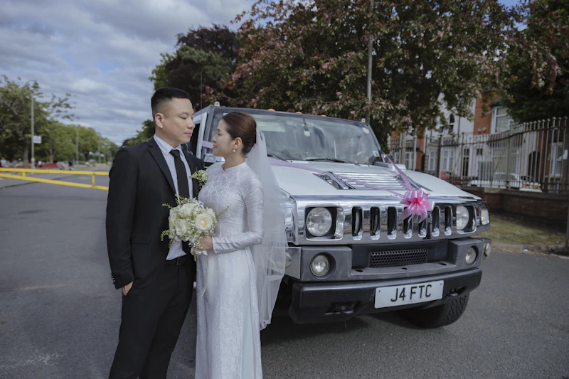 luxury couple beside a decorated limousine