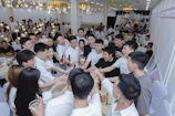 Group of friends toasting with drinks at a celebration.