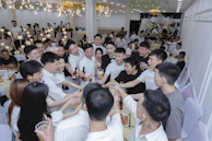 Group of friends toasting with drinks at a celebration.