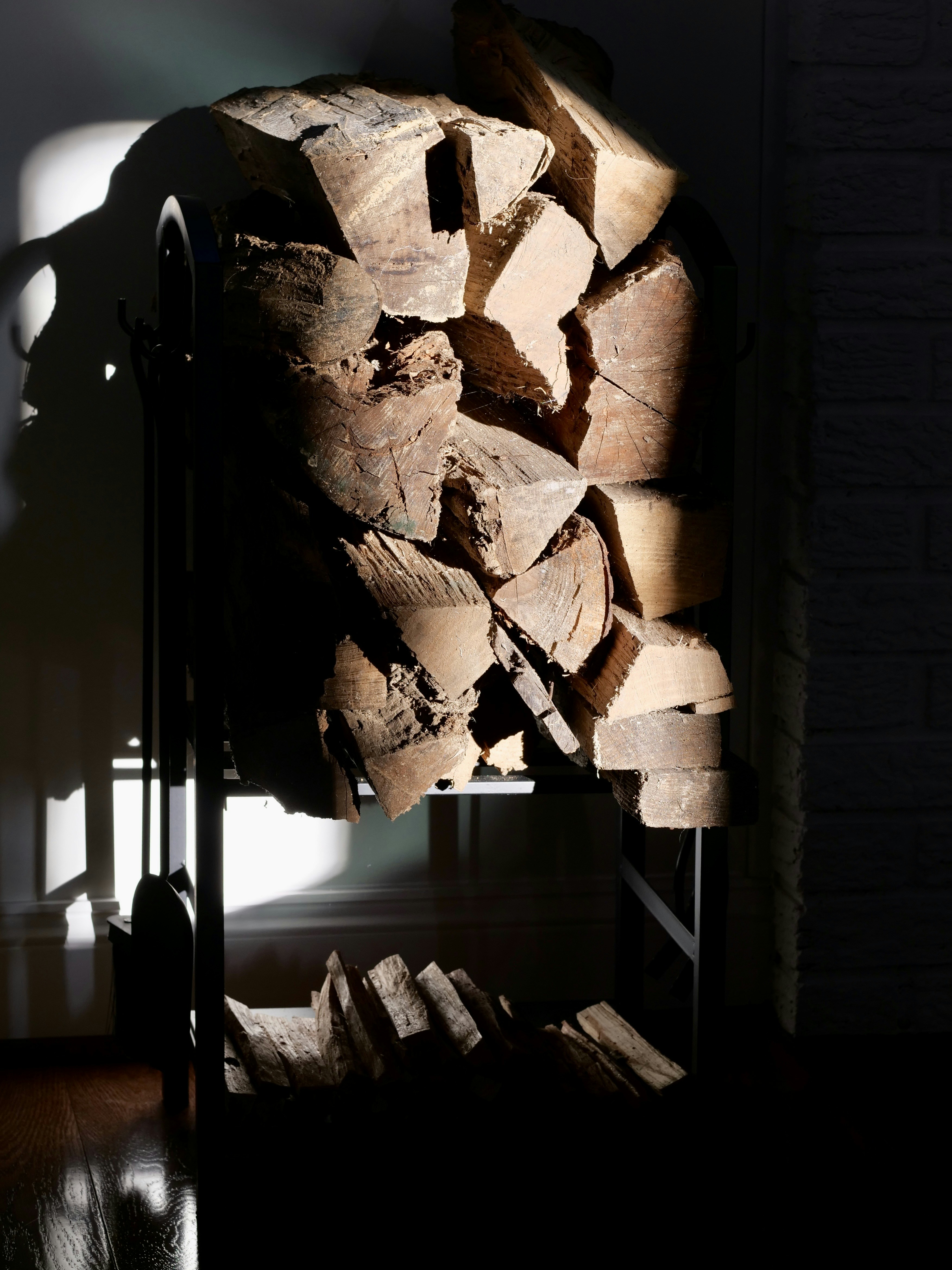 A stack of firewood on a metal rack