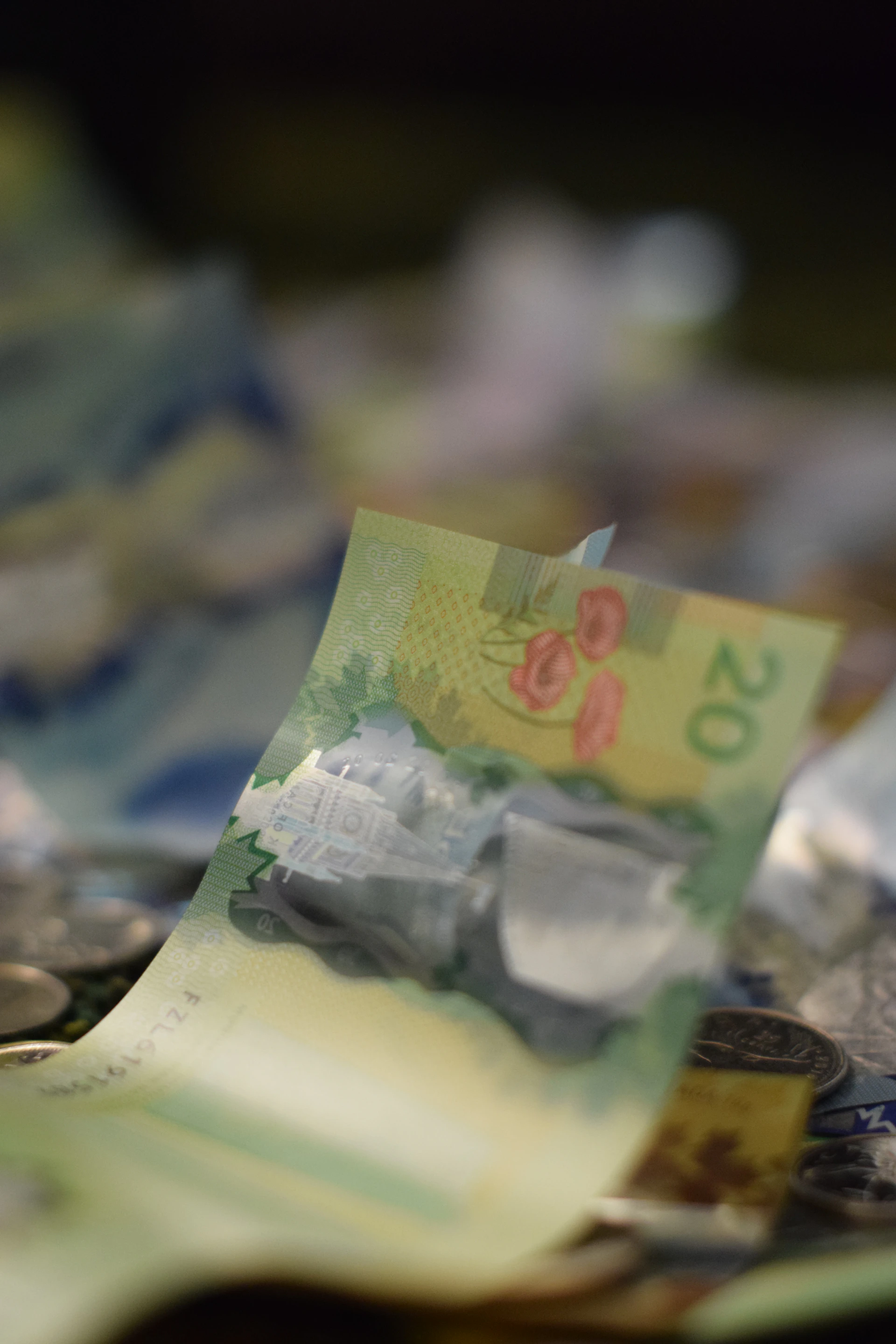 Canadian twenty dollar bill among coins and coins