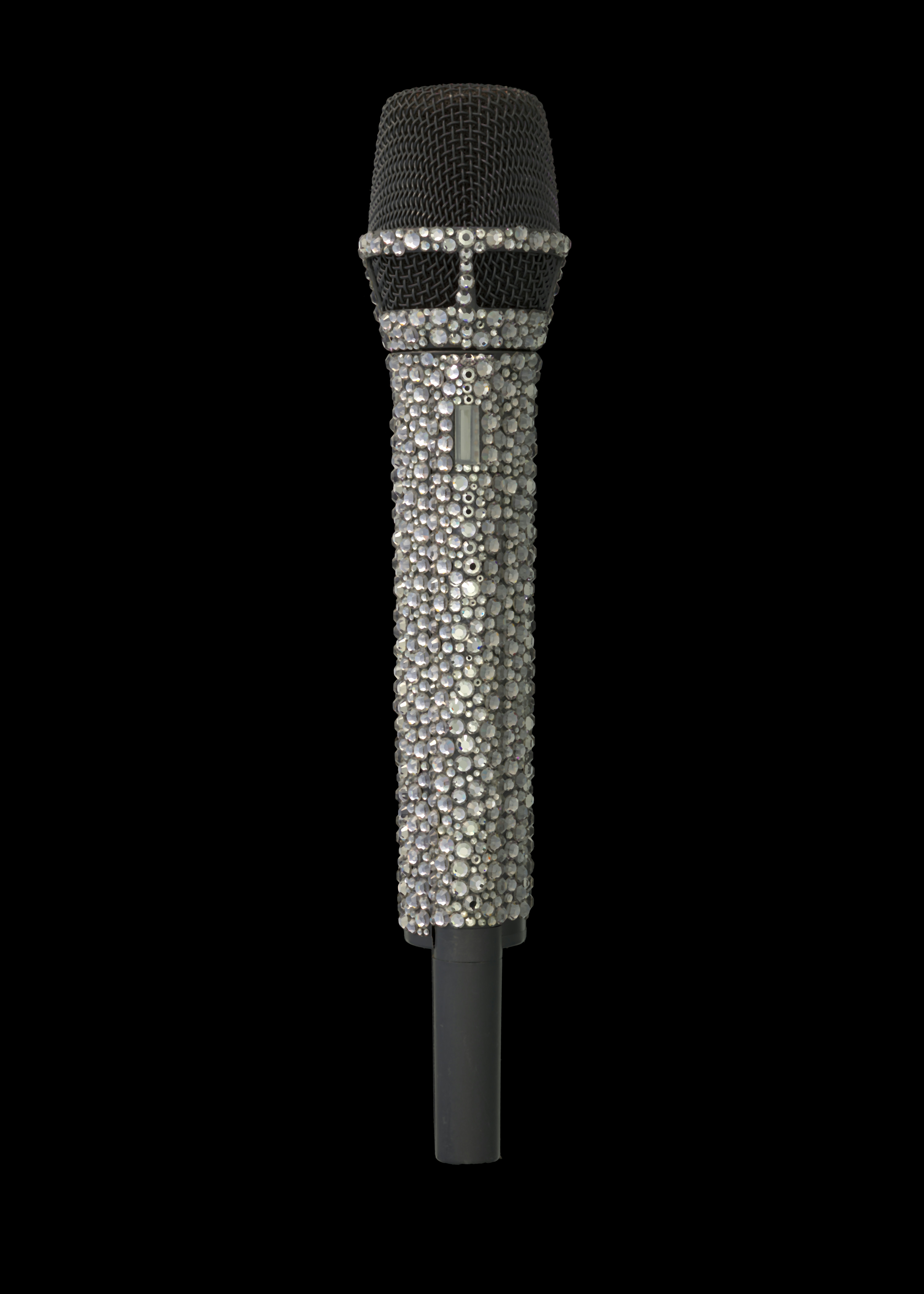 A microphone covered in sparkling rhinestones on black background